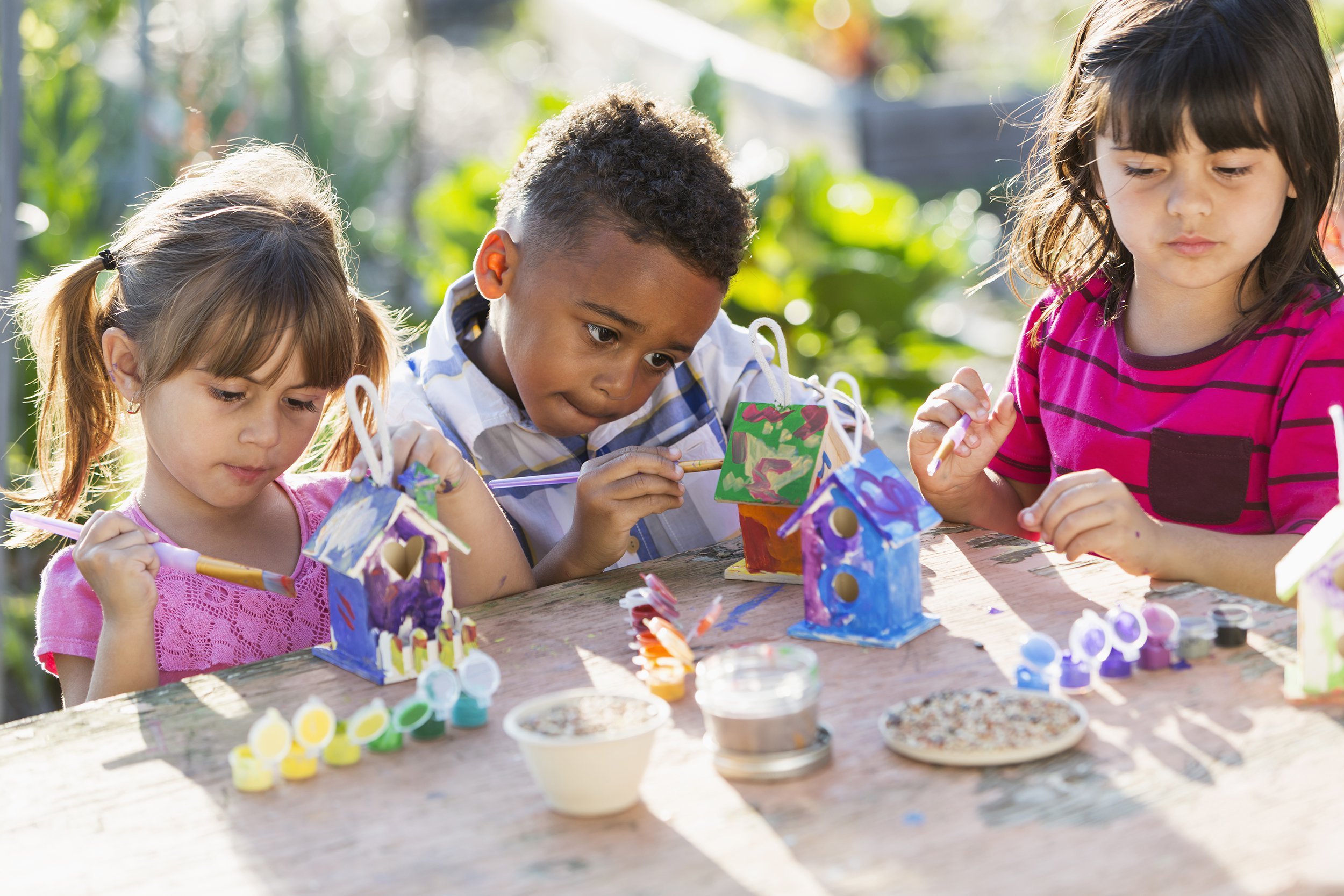 children painting bird houses