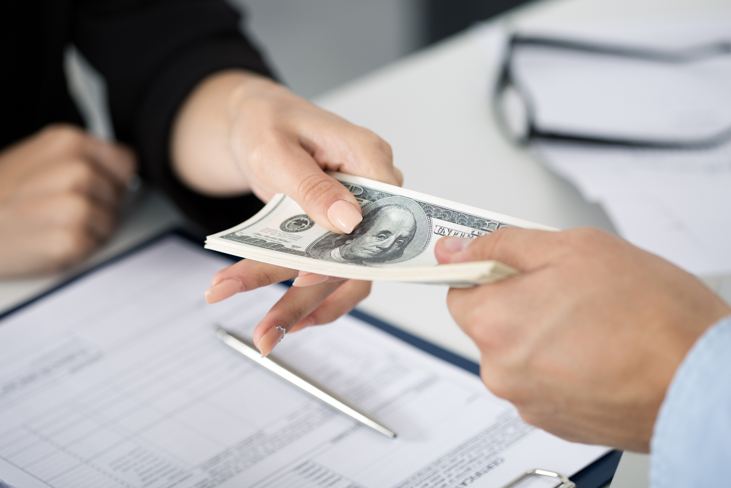 Business woman exchanging money with a customer