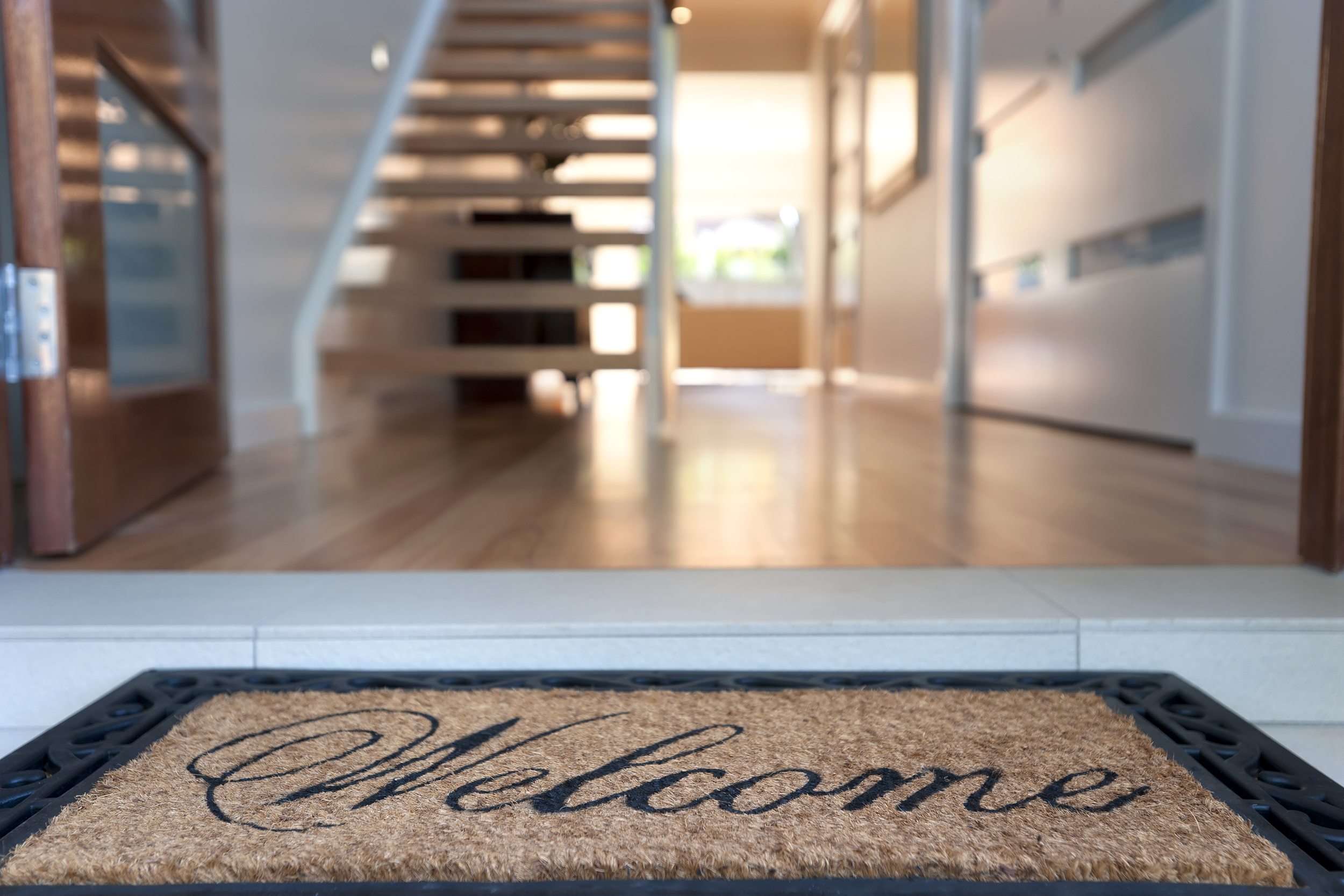 Welcome mat in front of a new home