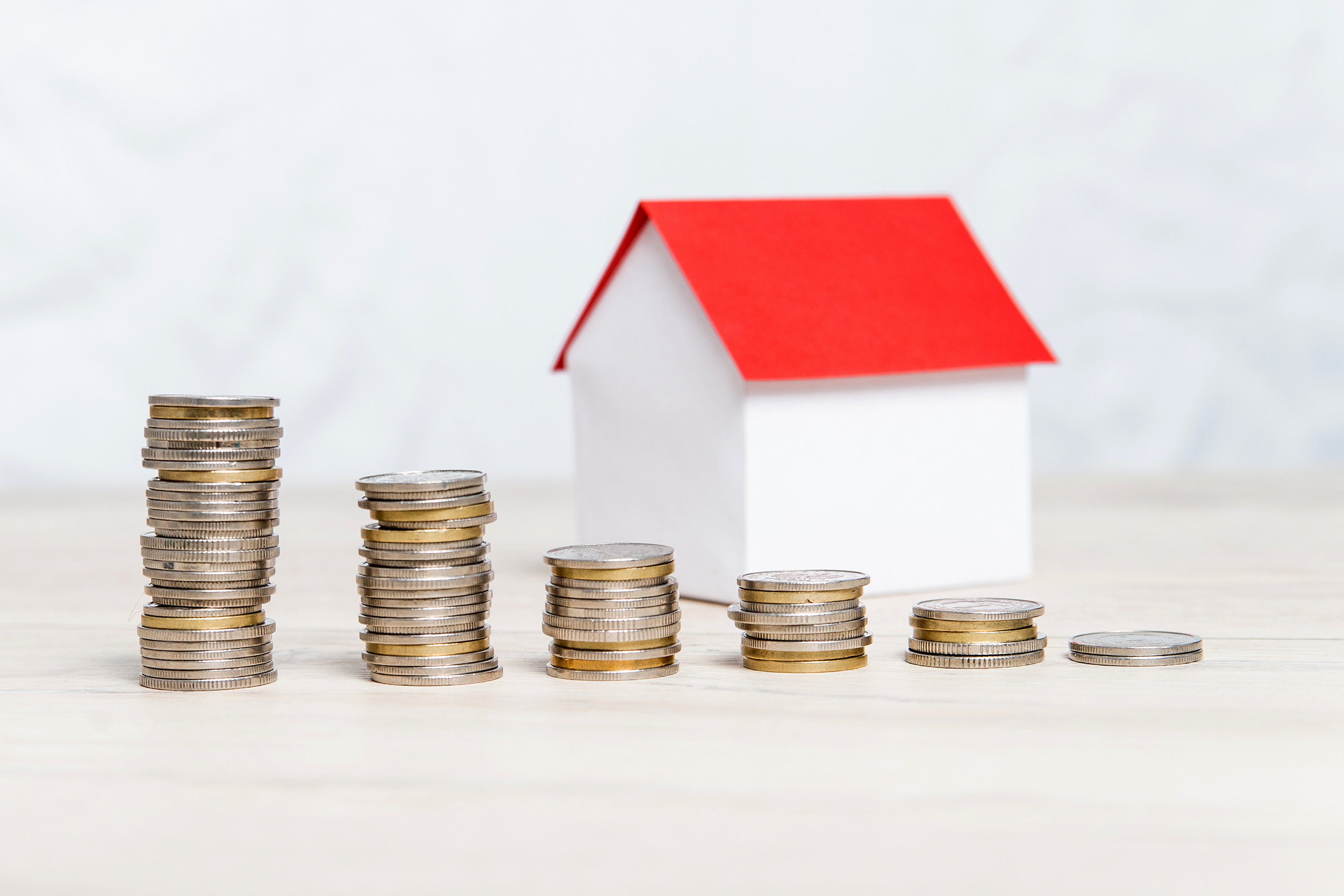 Decreasing coins in stacks in front of a model home
