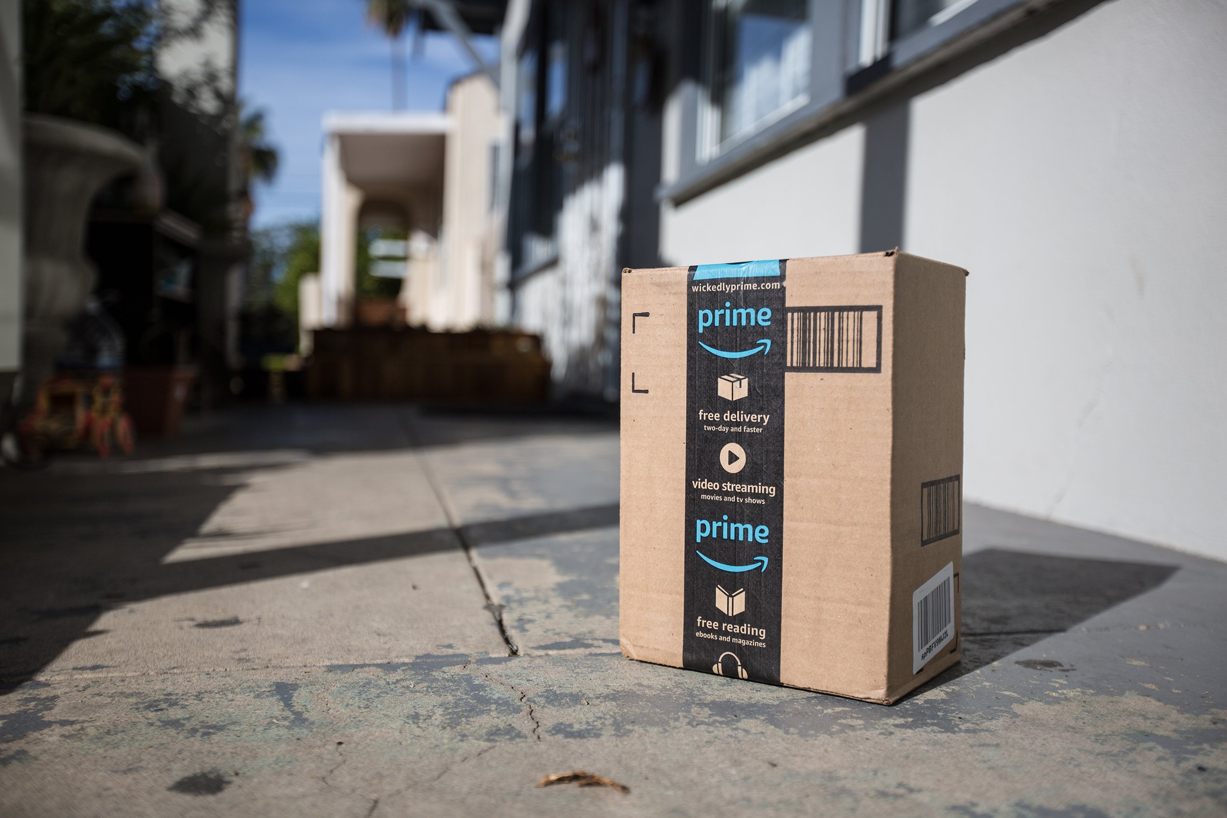 Amazon cardboard package delivery at front door