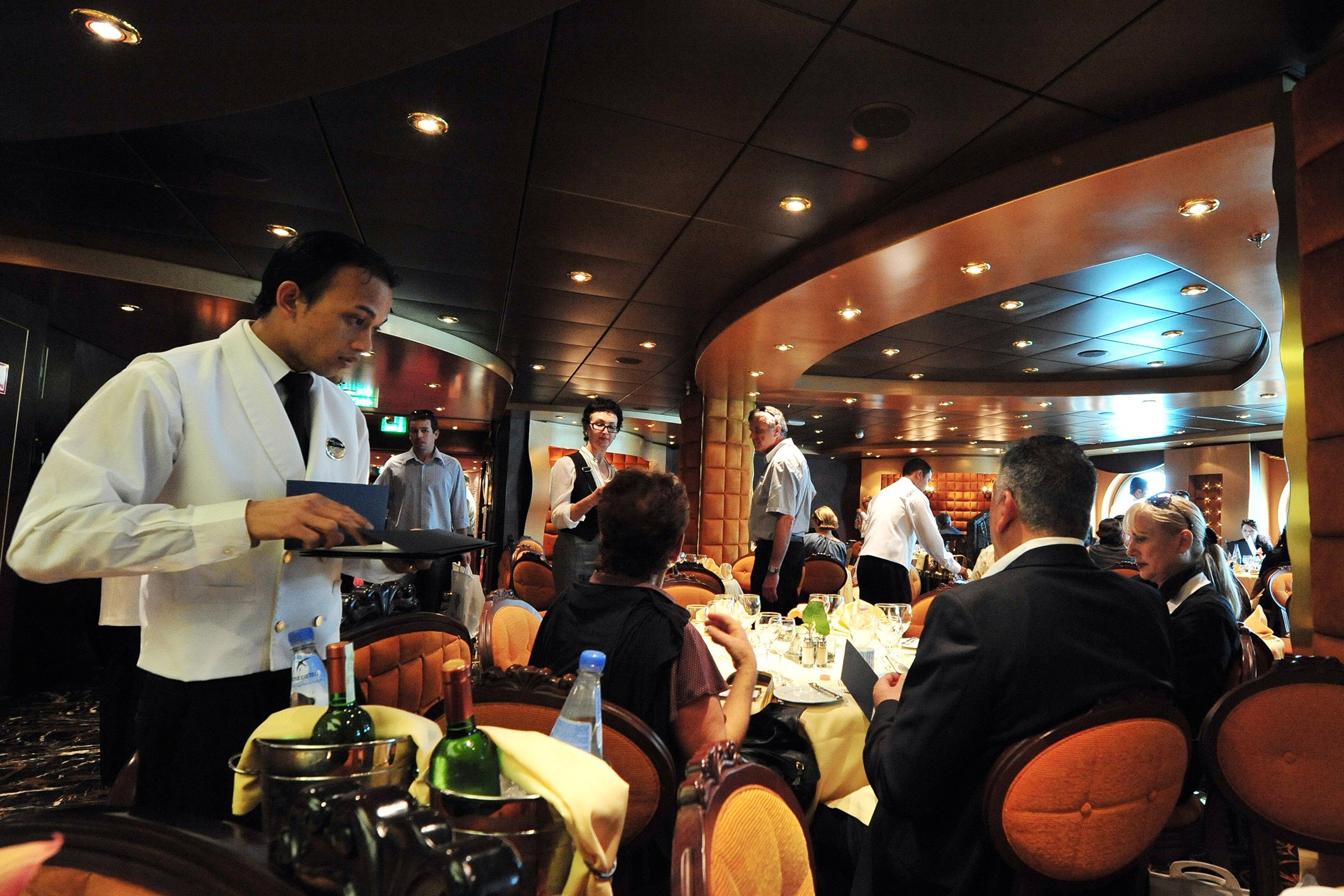customers enjoying meals at a specialty restaurant onboard a cruise ship