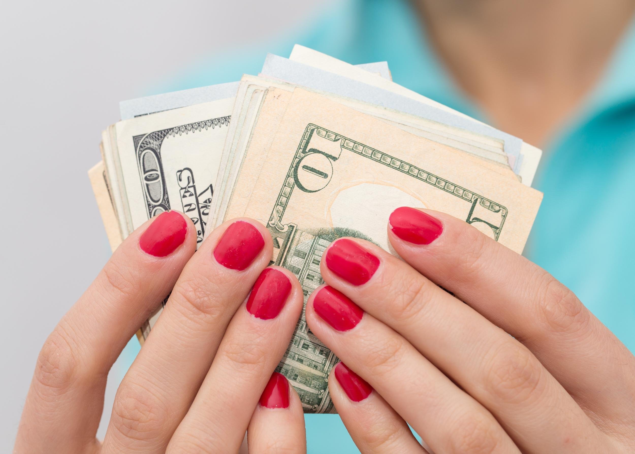 hand holding dollar bills