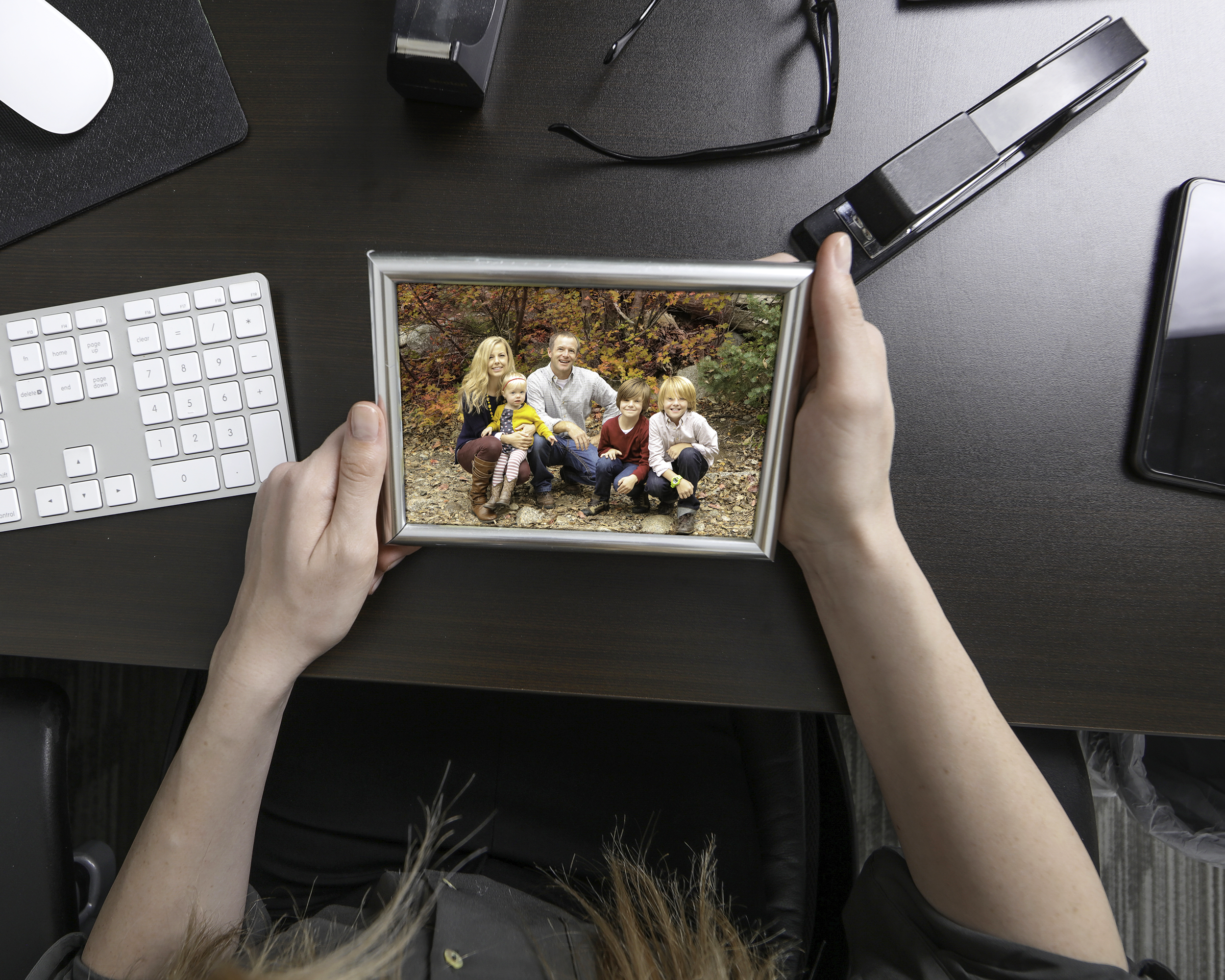 Holding picture of family at work desk