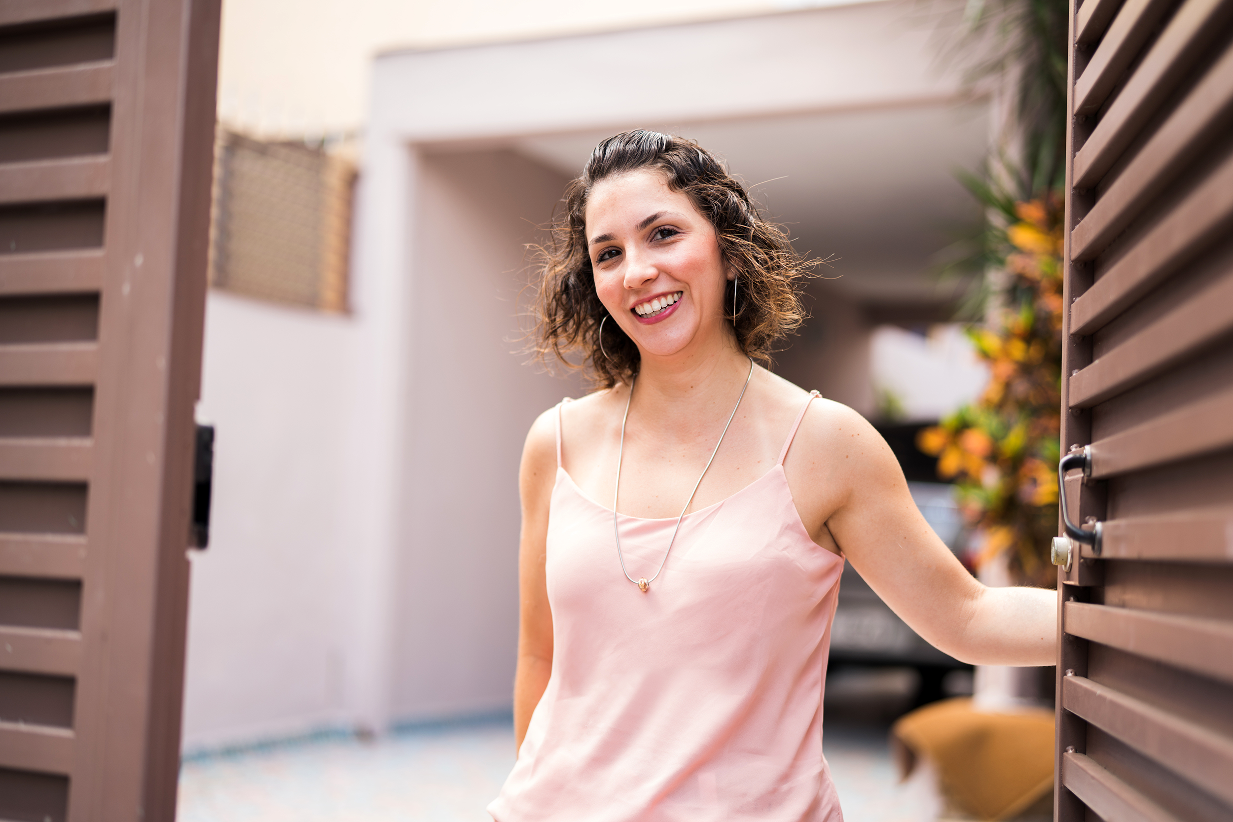 Woman opening her front door to welcome guests