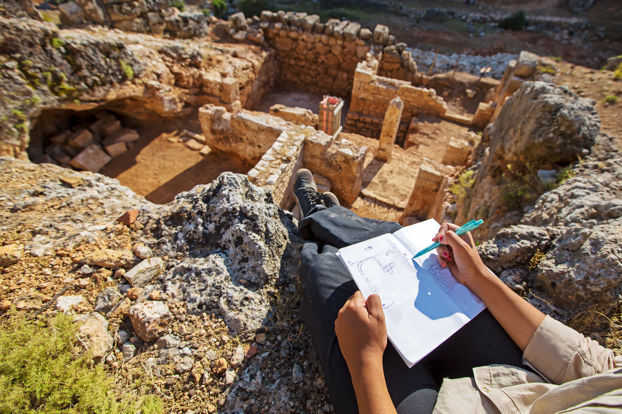 Archaeologist taking notes at a site