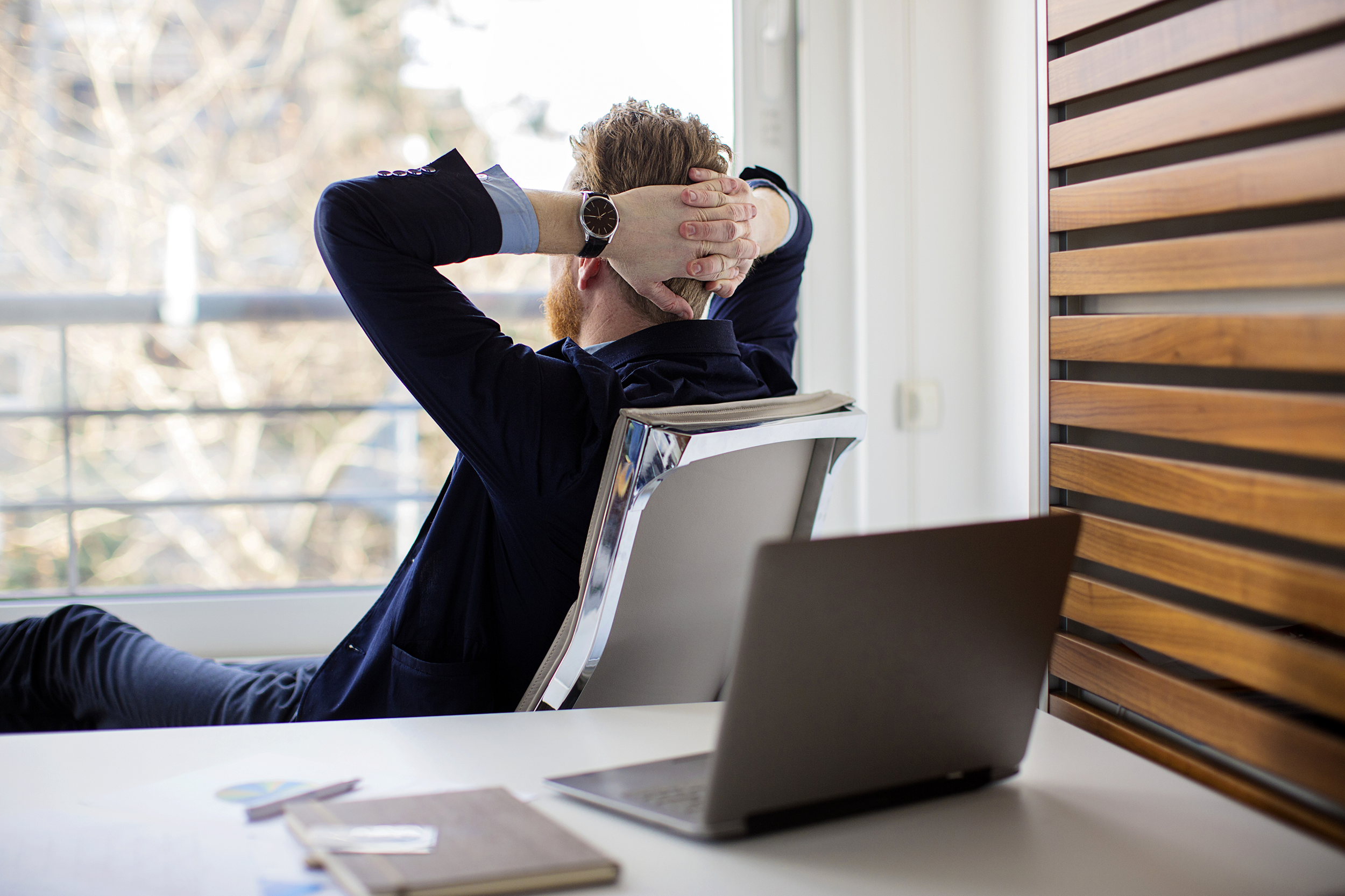 Man looking out the window in his office