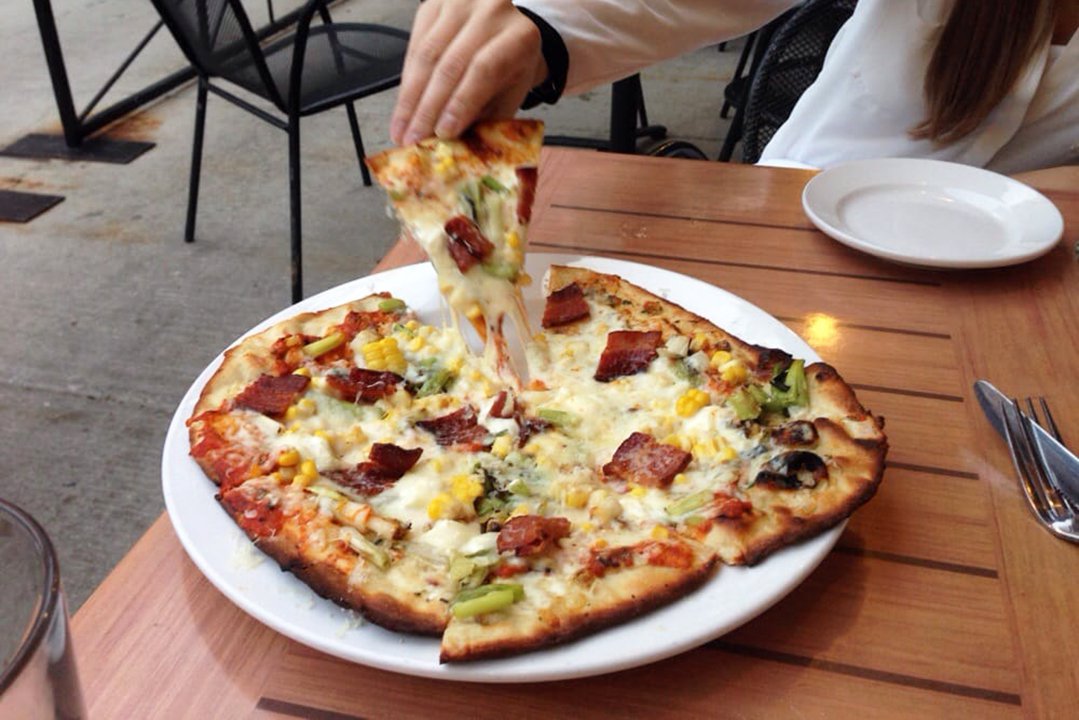 Pulling a slice of pizza