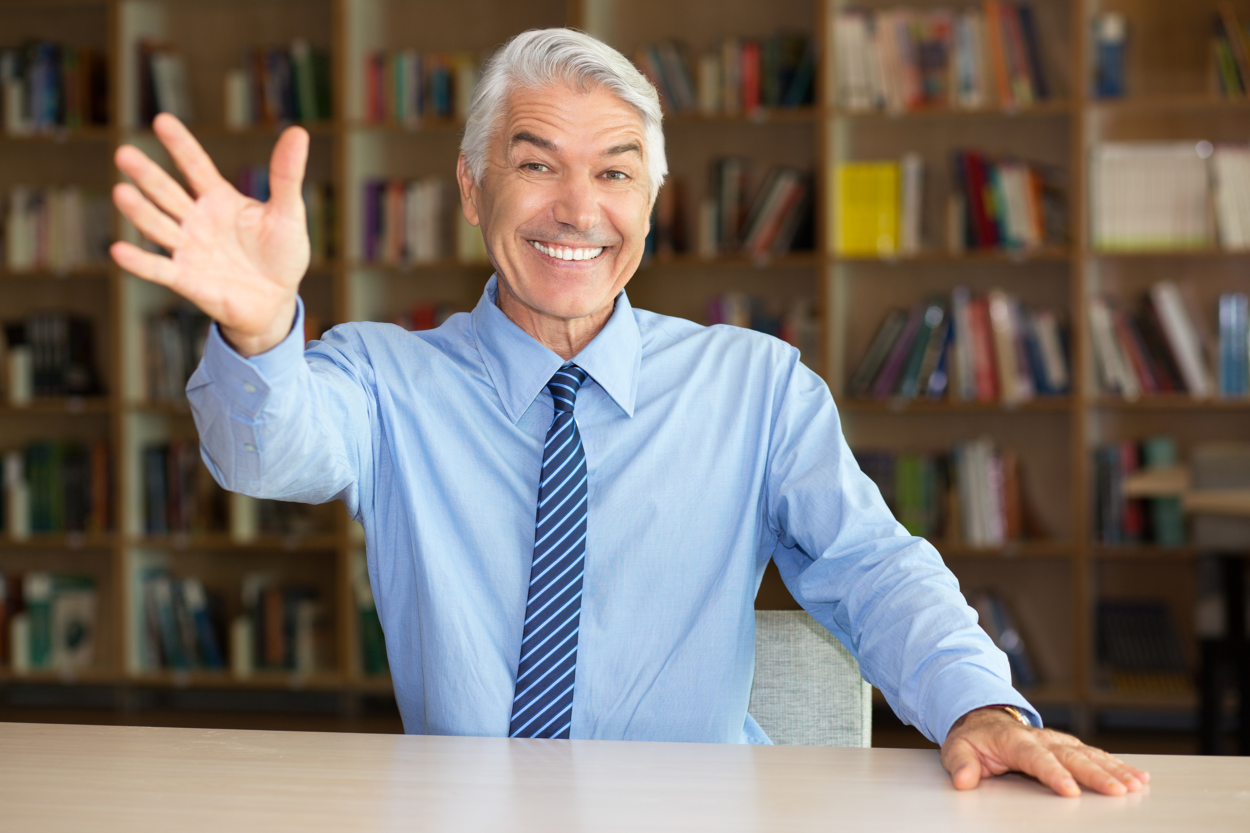 Happy businessman waving hello