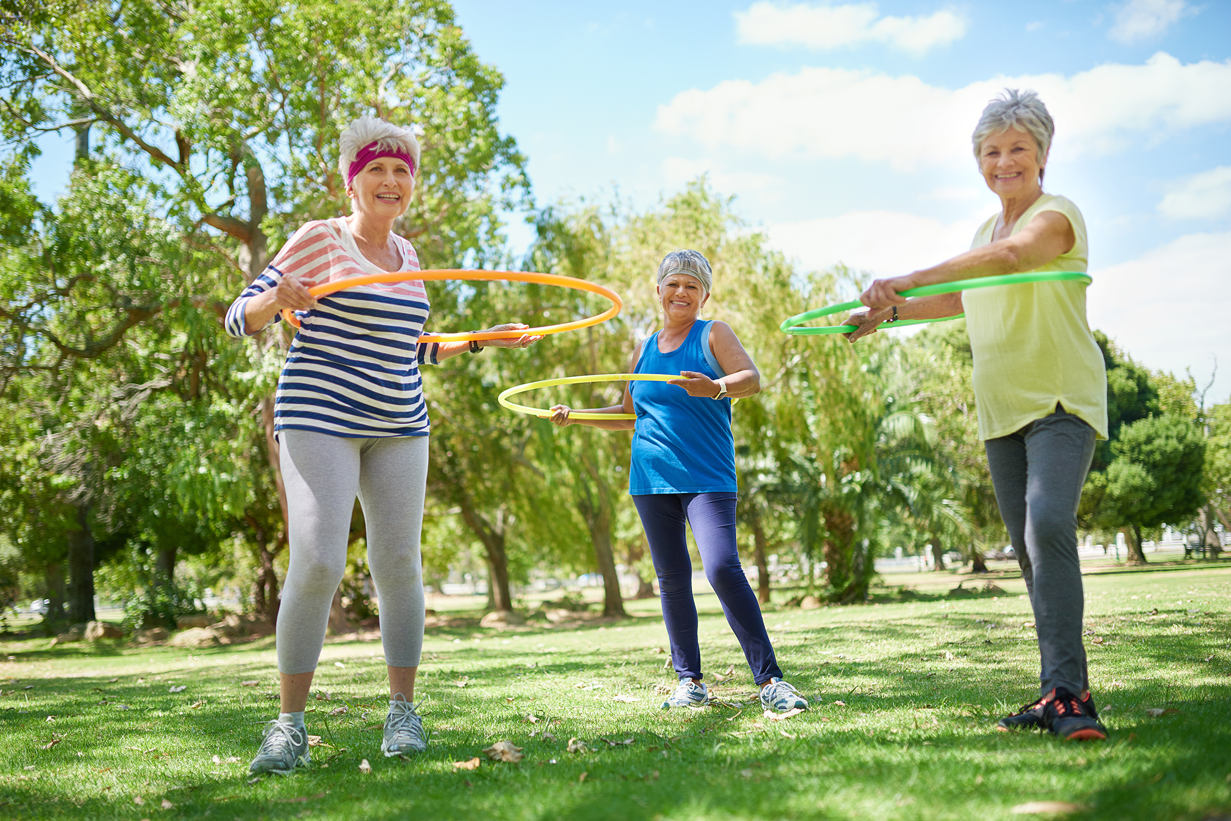 Senior women hula hooping in the park