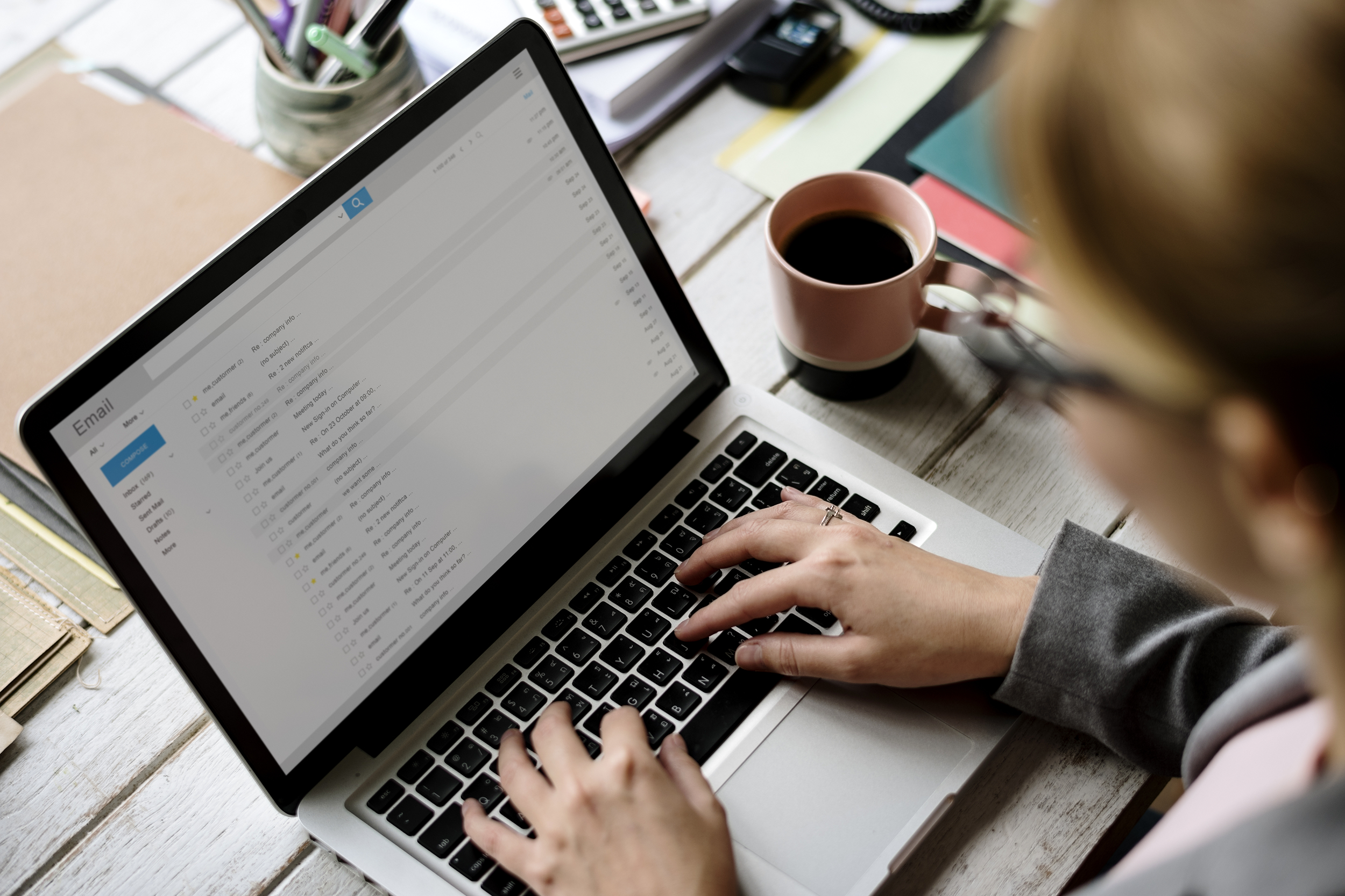 Woman answering emails on her laptop