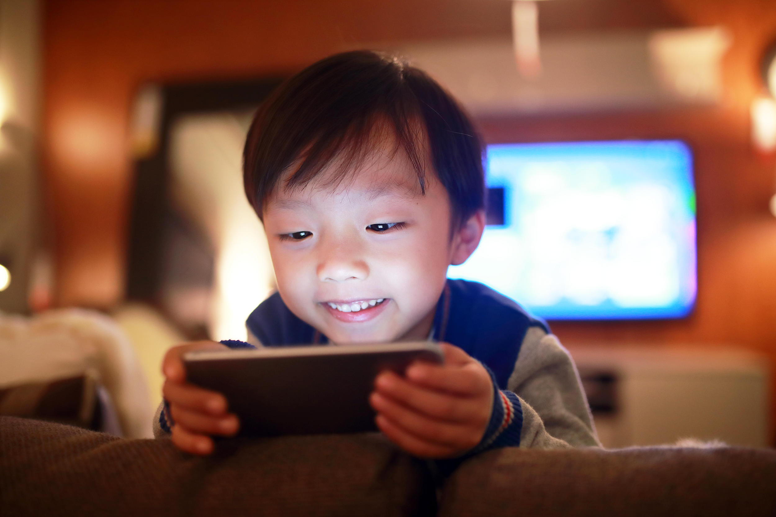 Young boy watching something on a smartphone