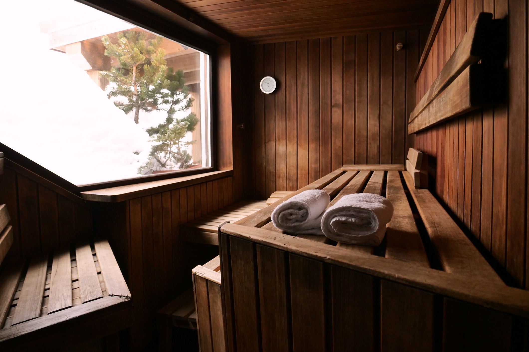 mountain wood sauna with a large window in which to relax