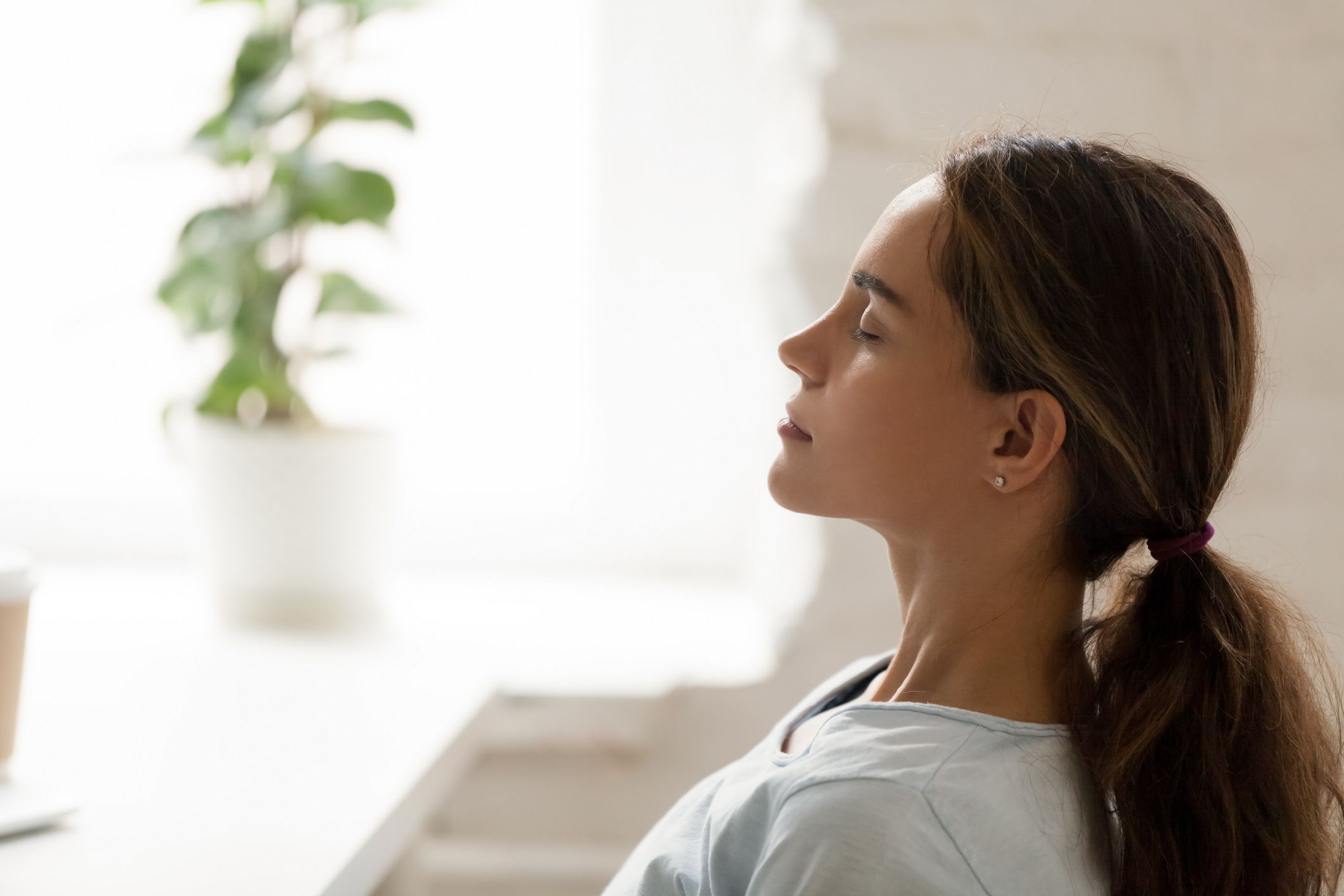 Side view young mixed race woman relaxing with closed eyes