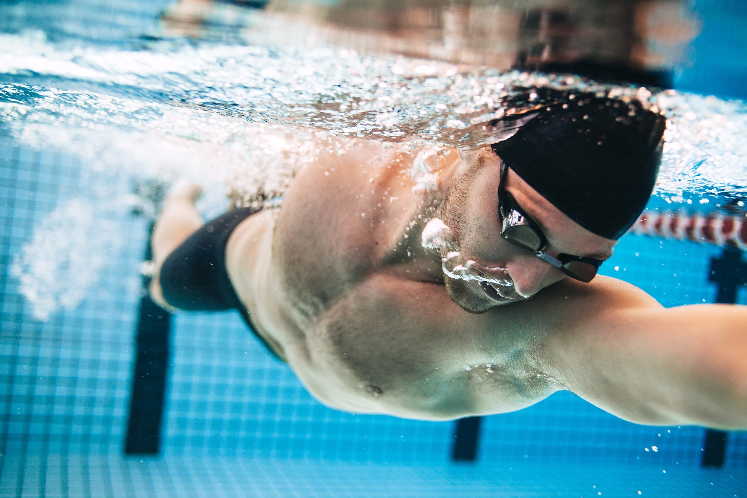 male swimmer practicing in swimming pool