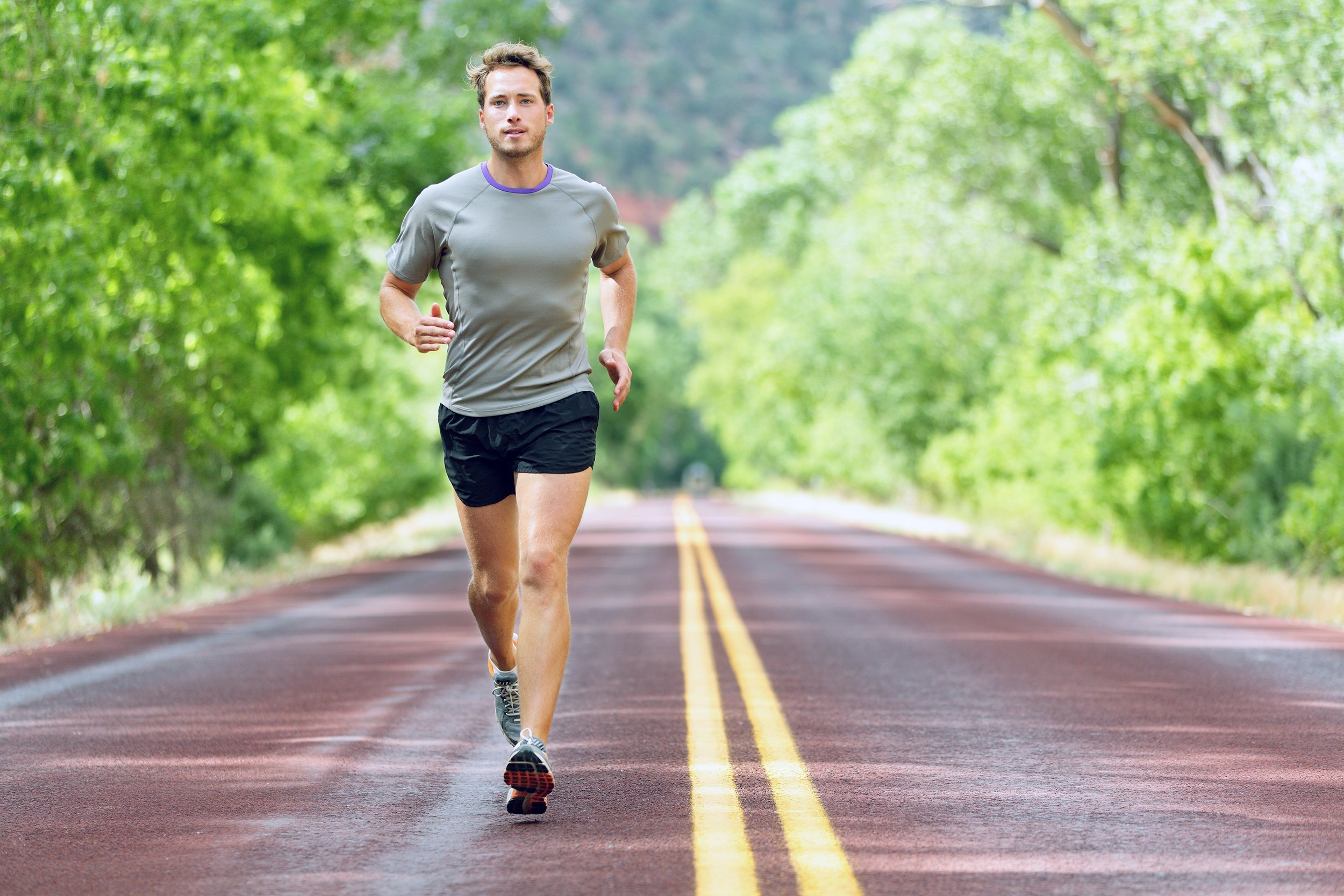 runner man running on road