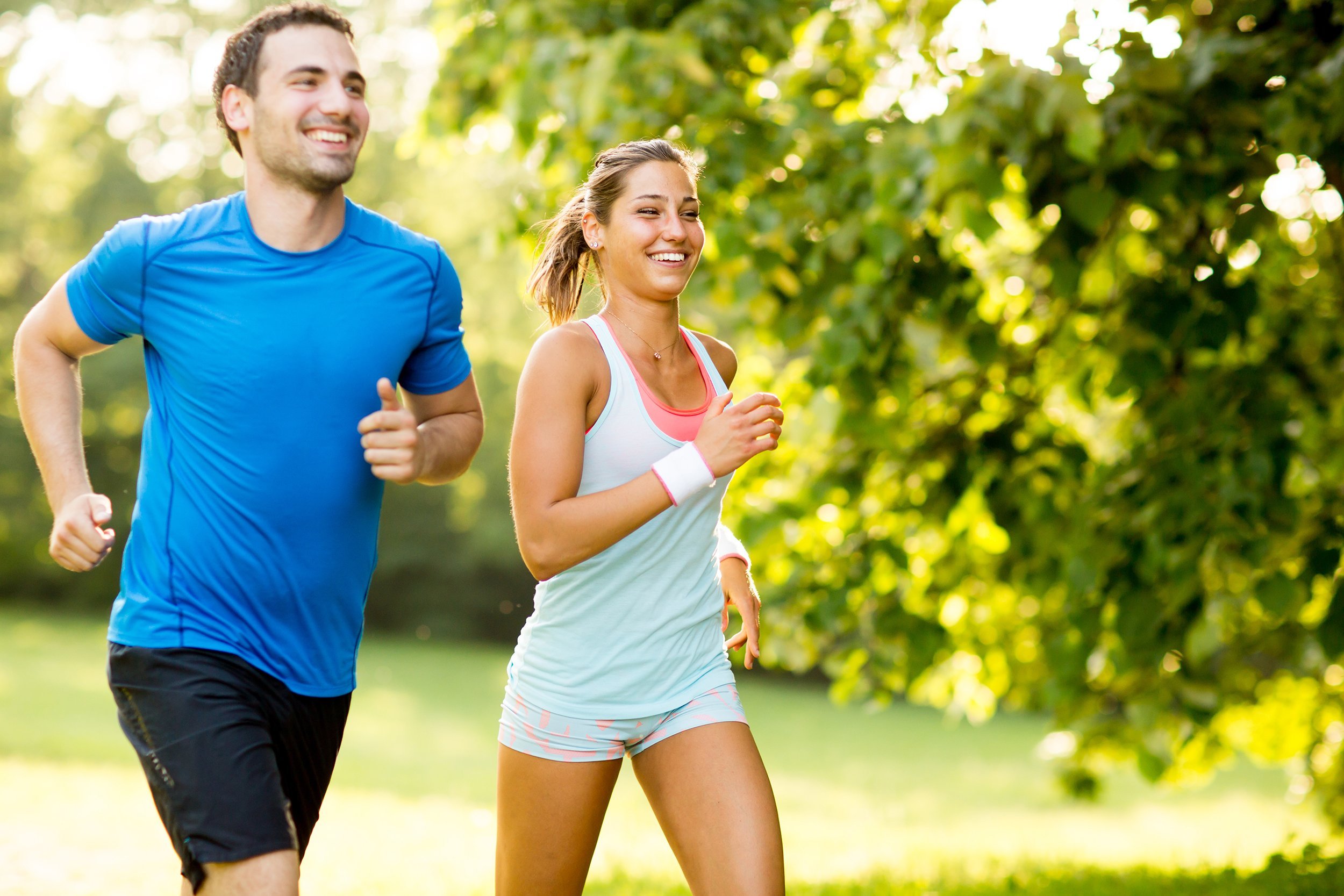 young couple running in the park