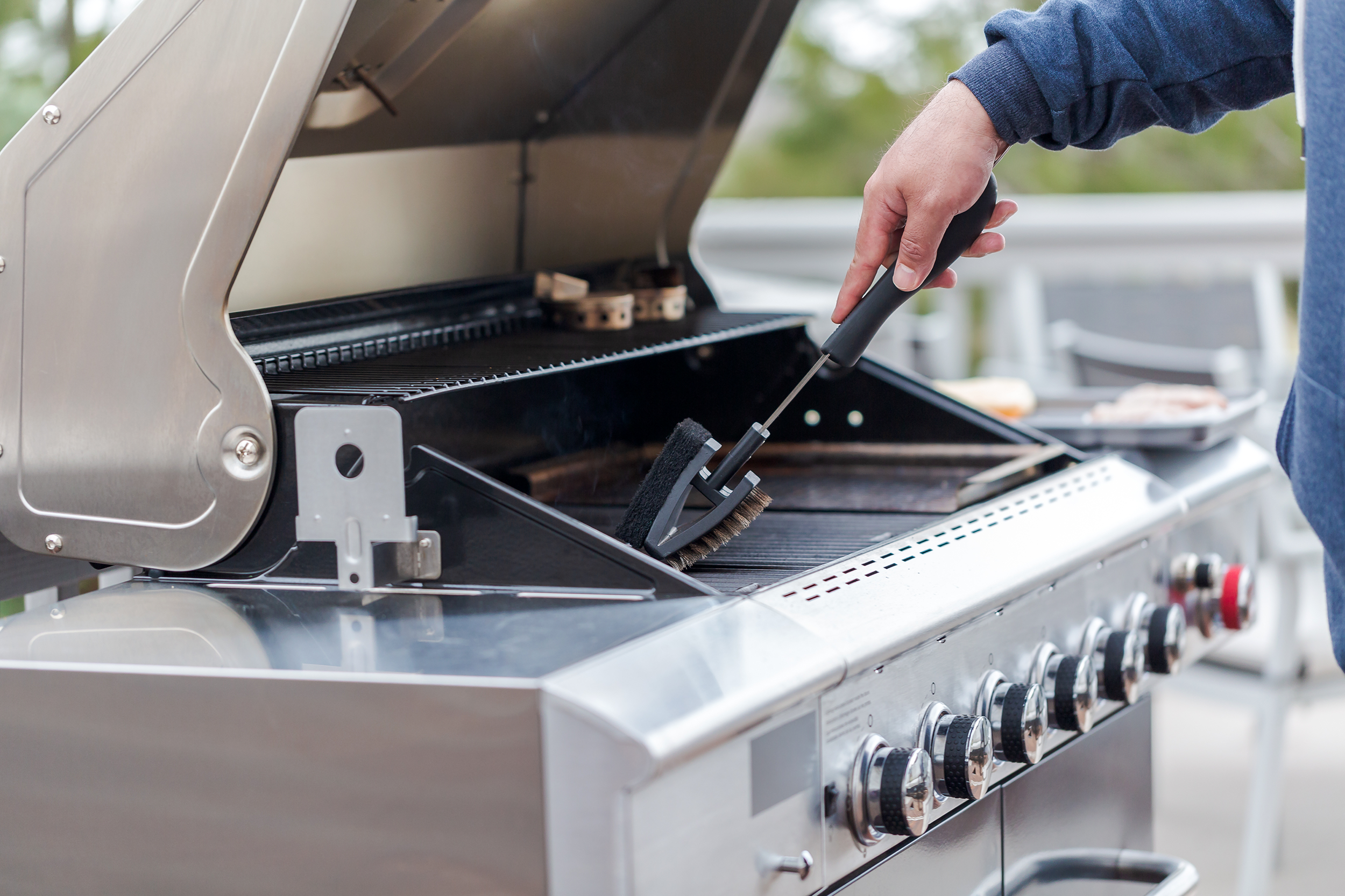 Man cleaning his grill