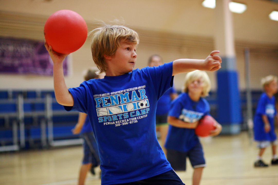 Young boys playing dodgeball in a gym