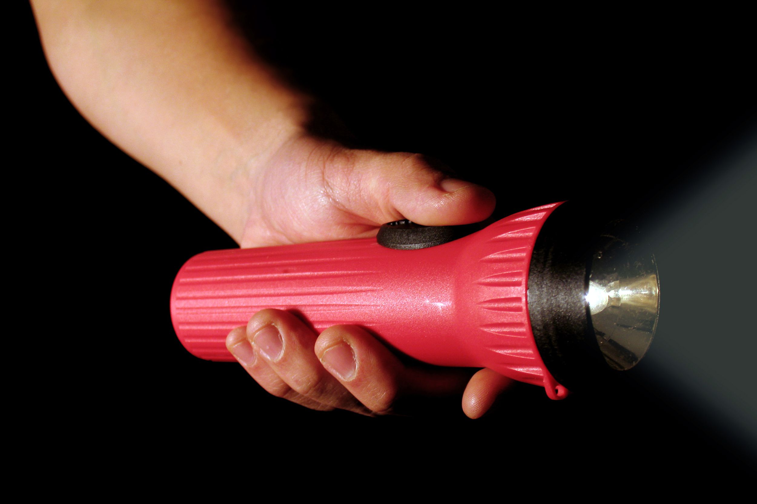 Closeup of kid holding a flashlight