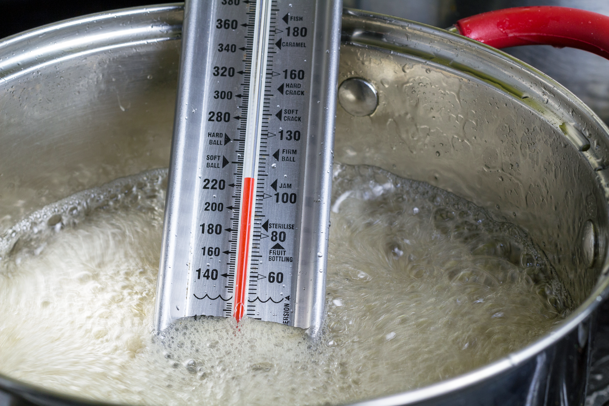 Candy thermometer in boiling sugar