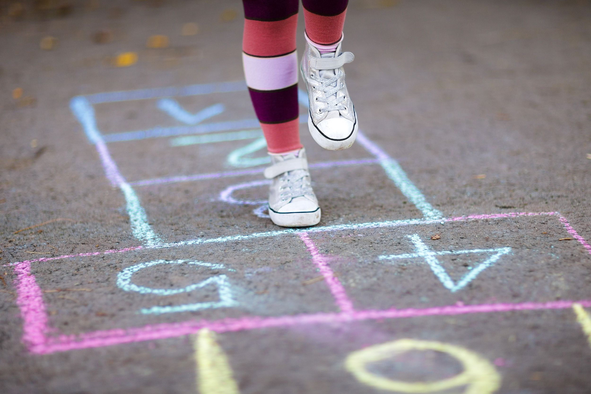 Little girl playing hopscotch