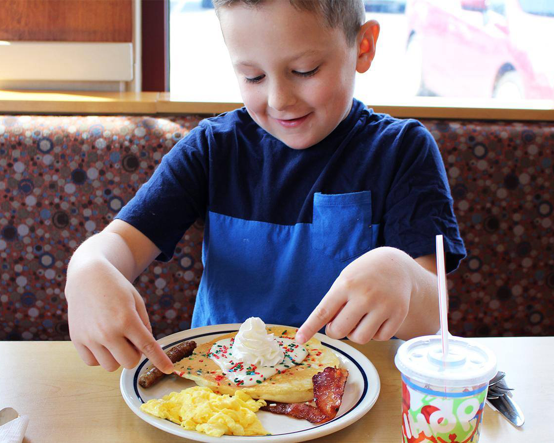 Little boy eating pancakes at IHOP