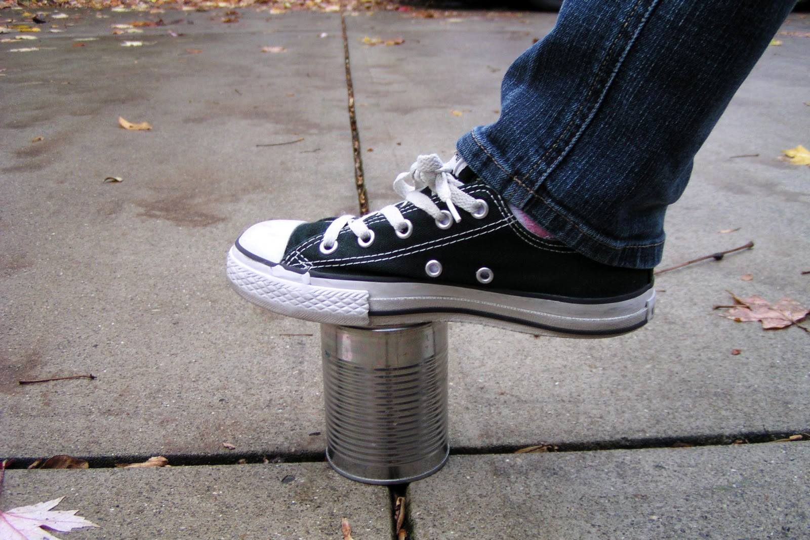 Foot stepping on a tin can