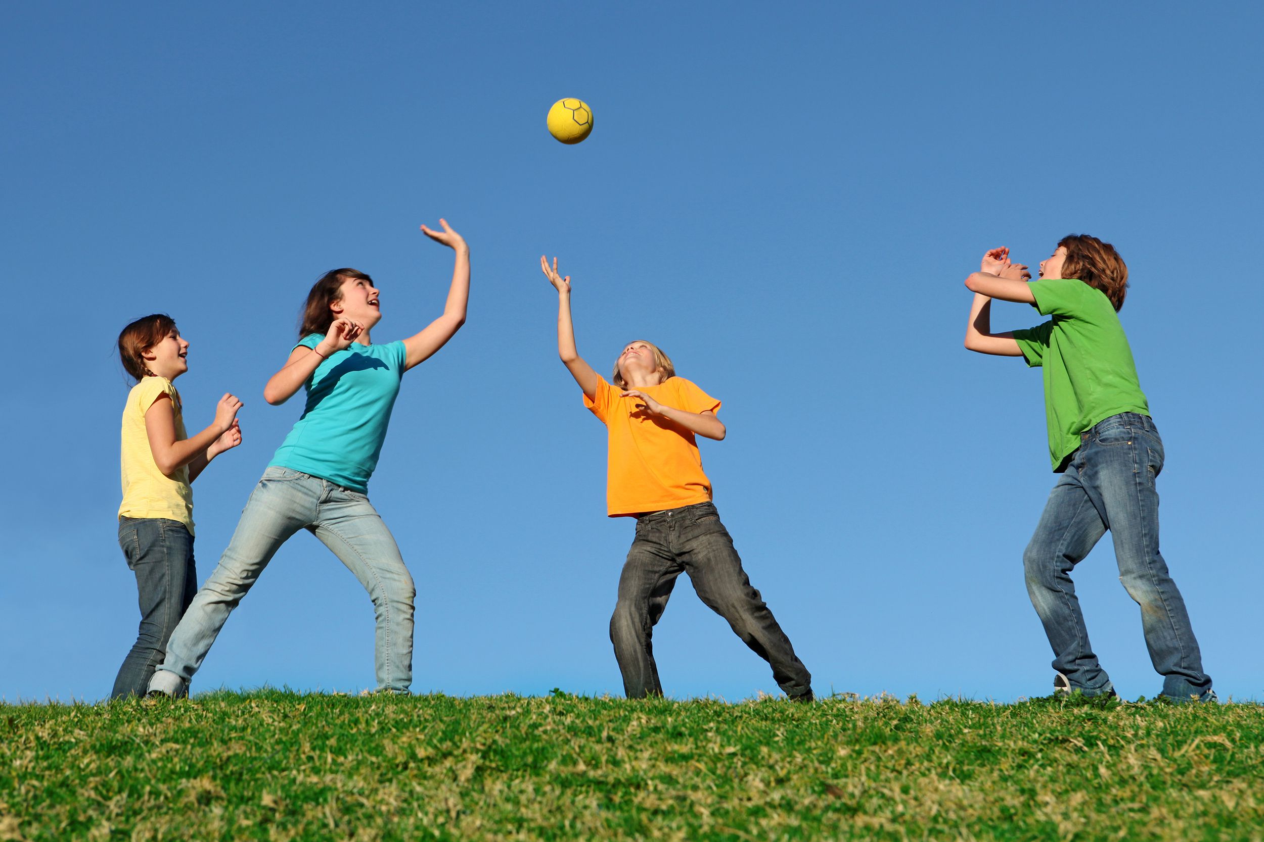 Kids throwing a ball in the air