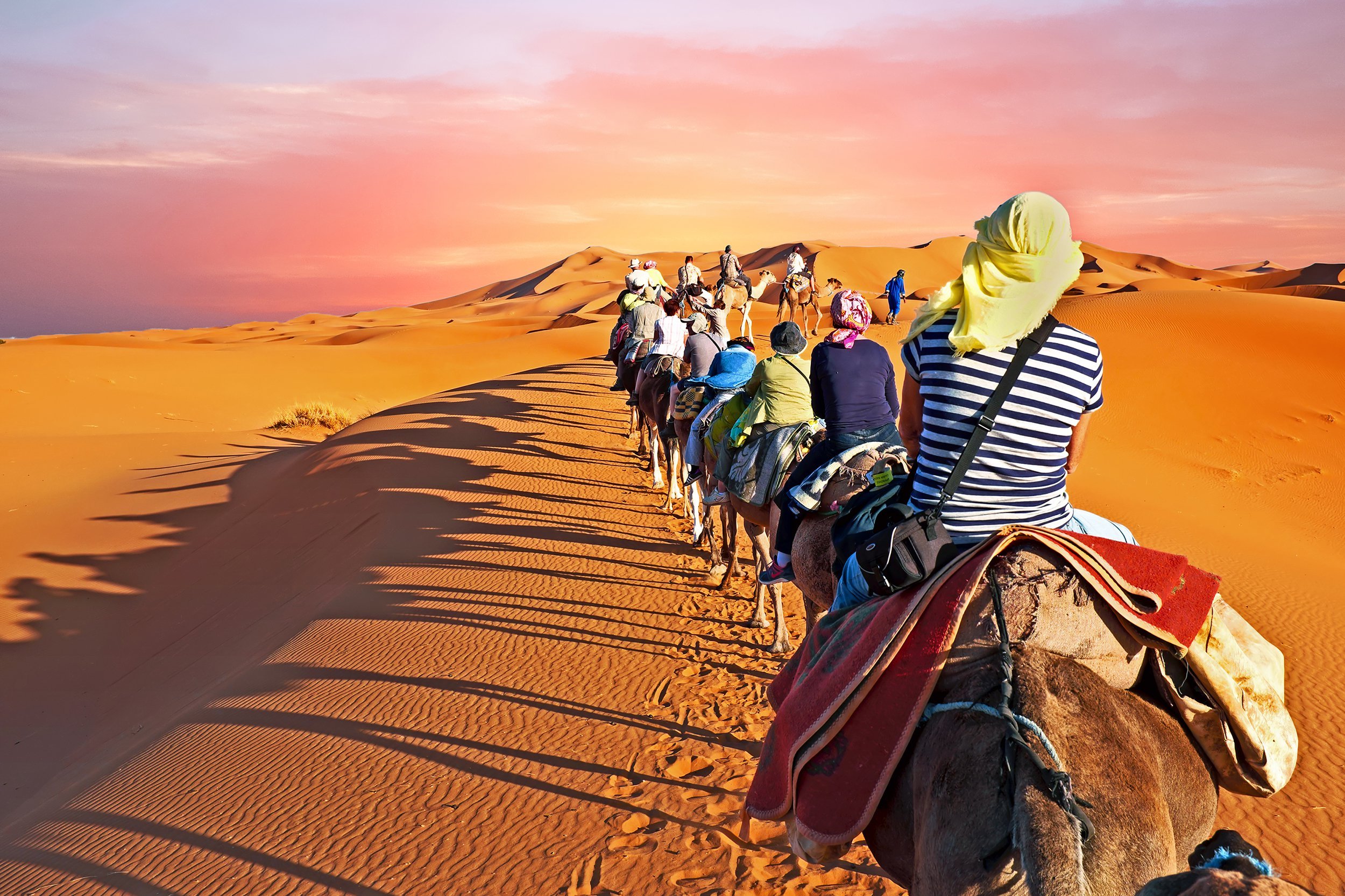 Riding camels across the Sahara Desert, Morocco