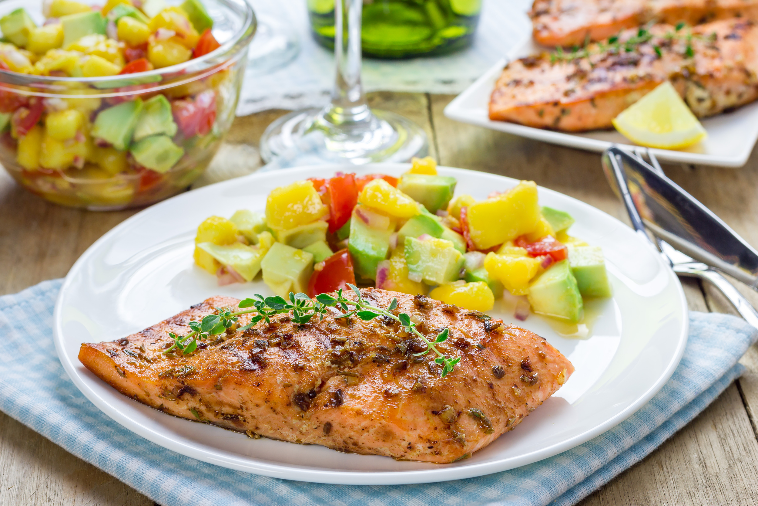 Healthy summer dish of grilled salmon and mango salad