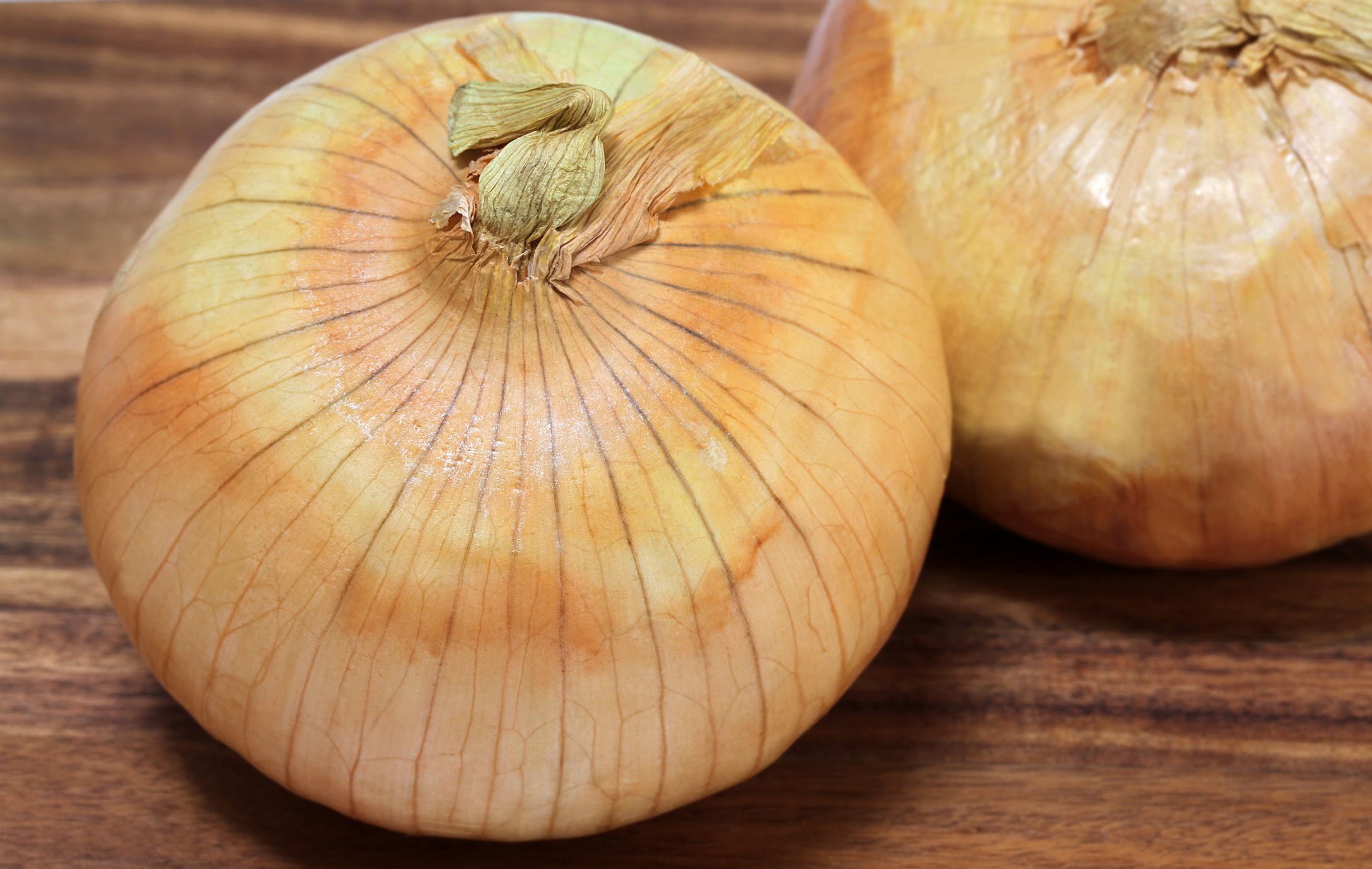 Macro image of Vidalia onions also known as sweet onions with selective focus on foreground top onion.
