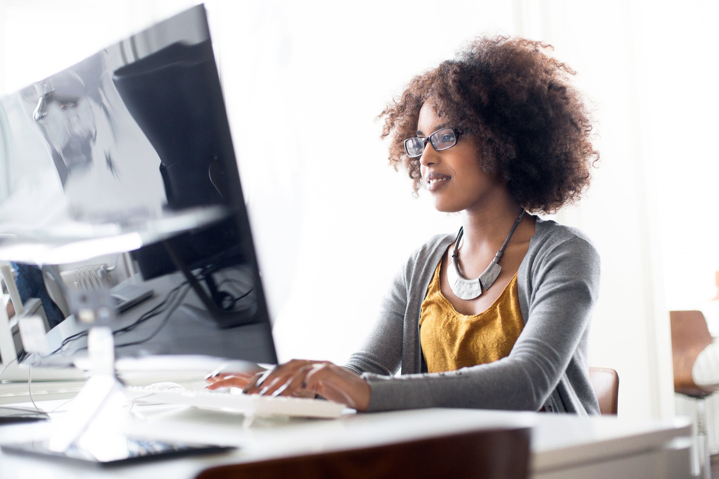 young women working on desktop computer