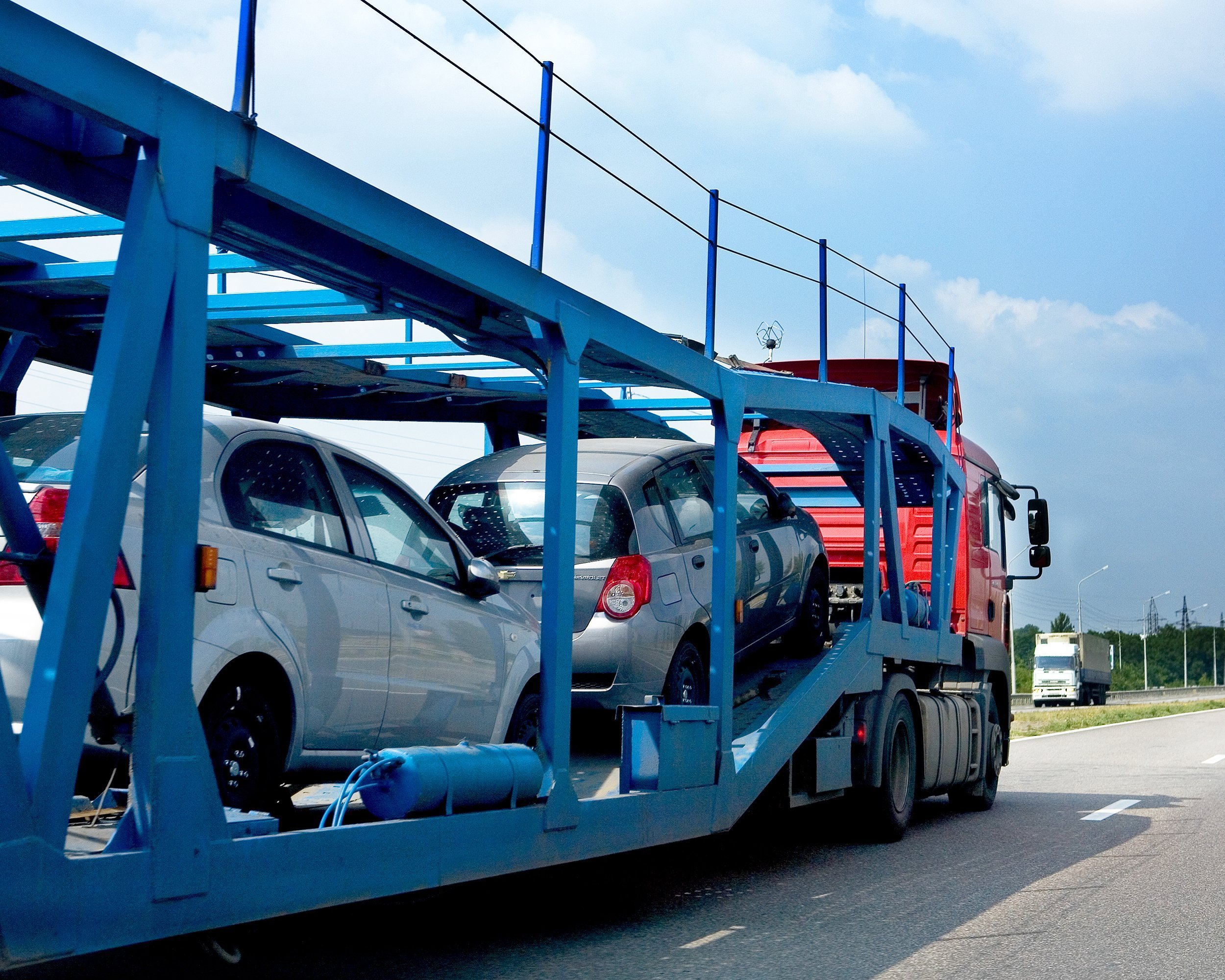 trailer transporting cars on highway