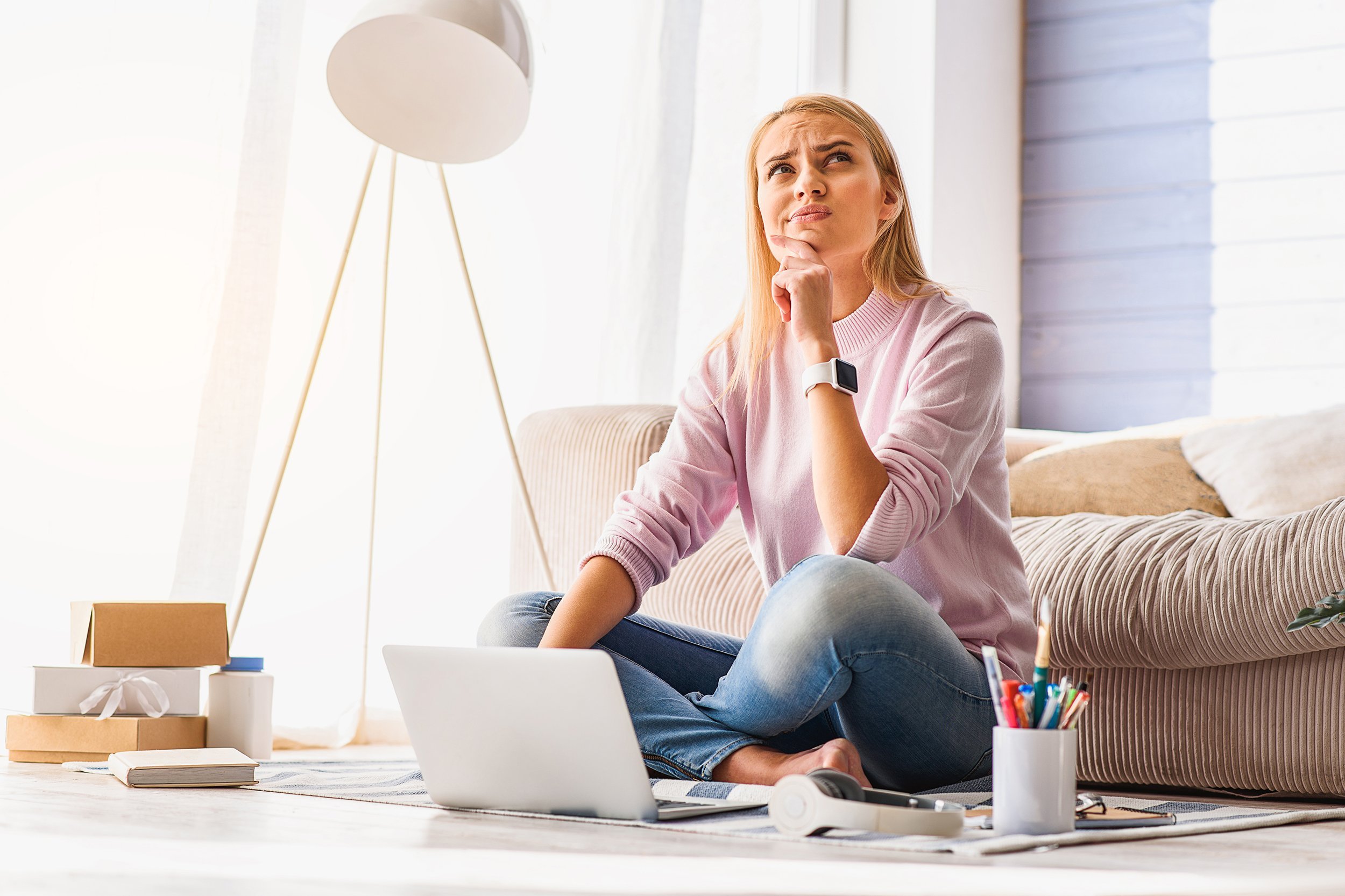 woman making serious decision while sitting on the floor of her home