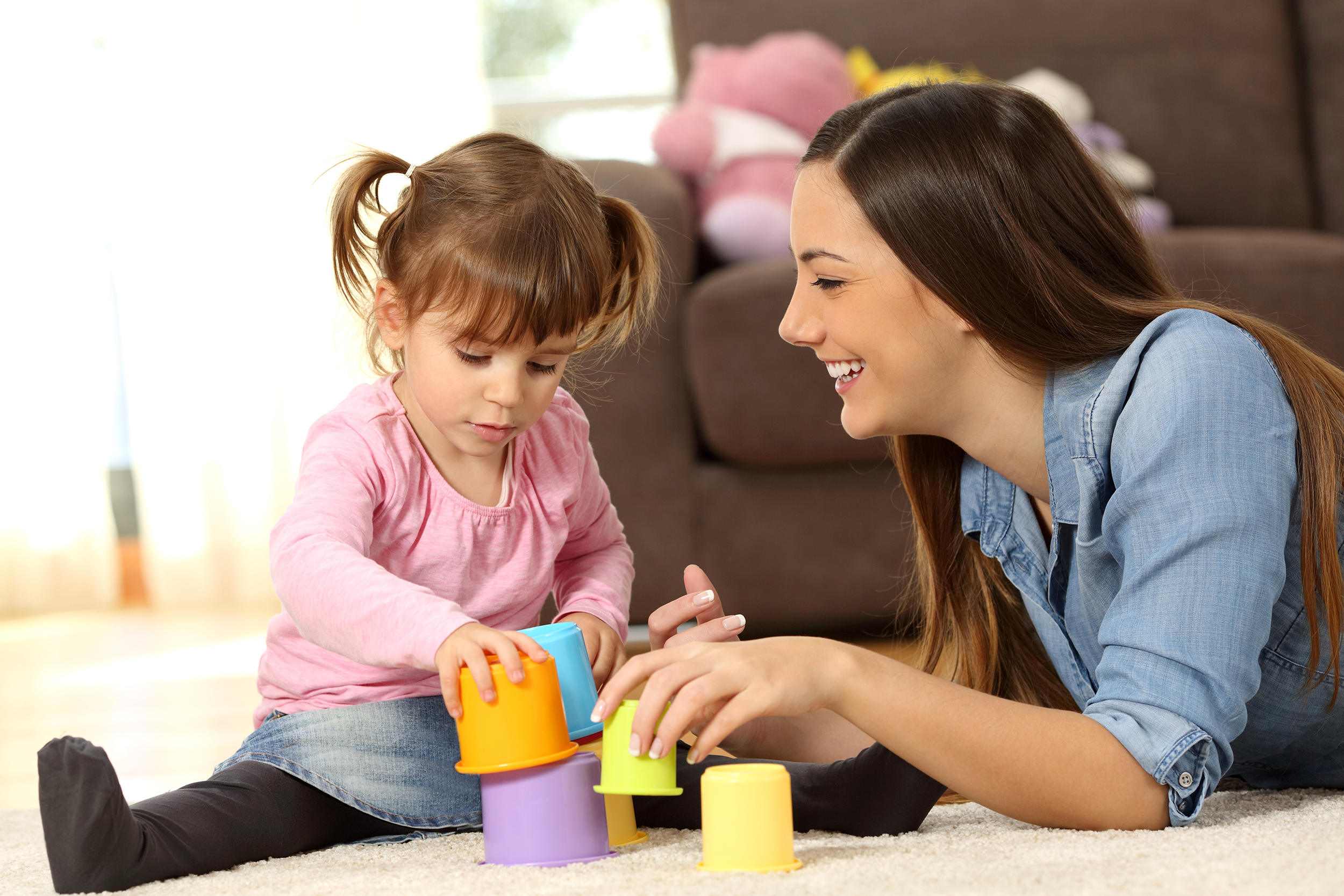 Babysitter playing with a toddler