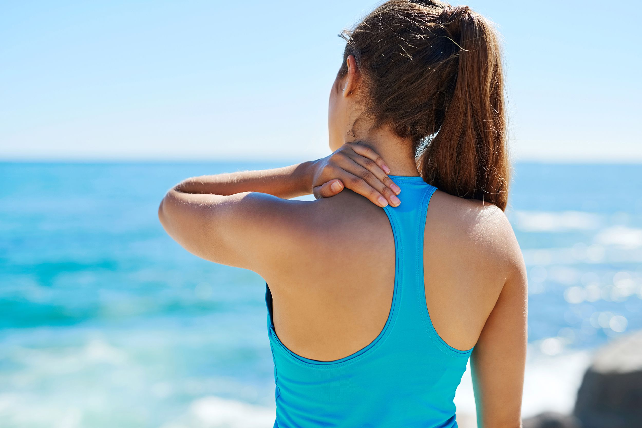 woman with neck injury at the beach
