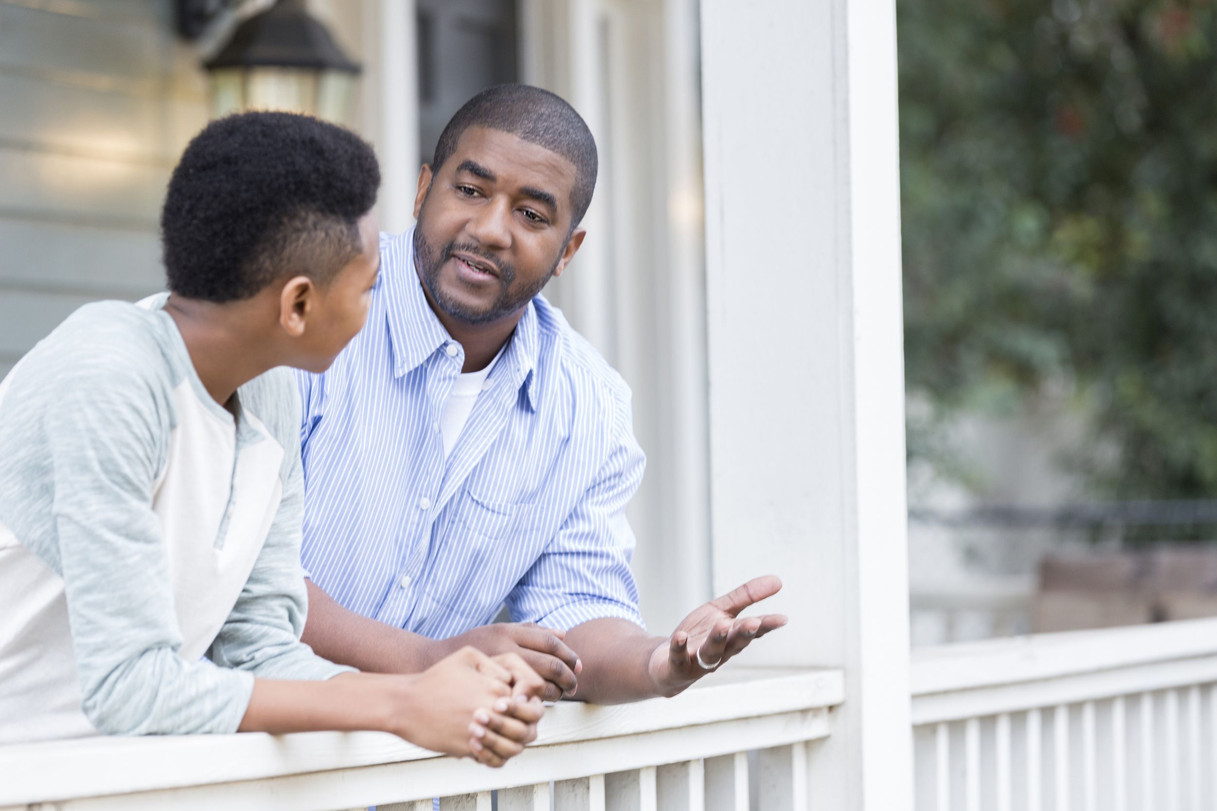 father and son in serious front porch conversation
