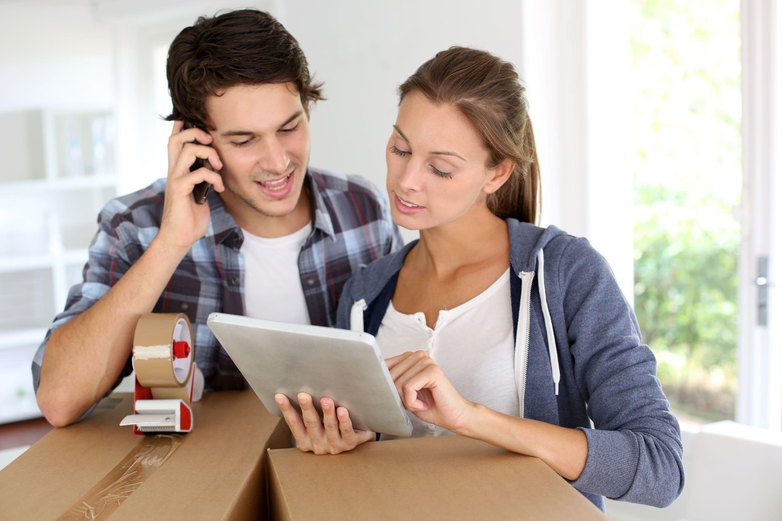 couple calling transport company to move in new house