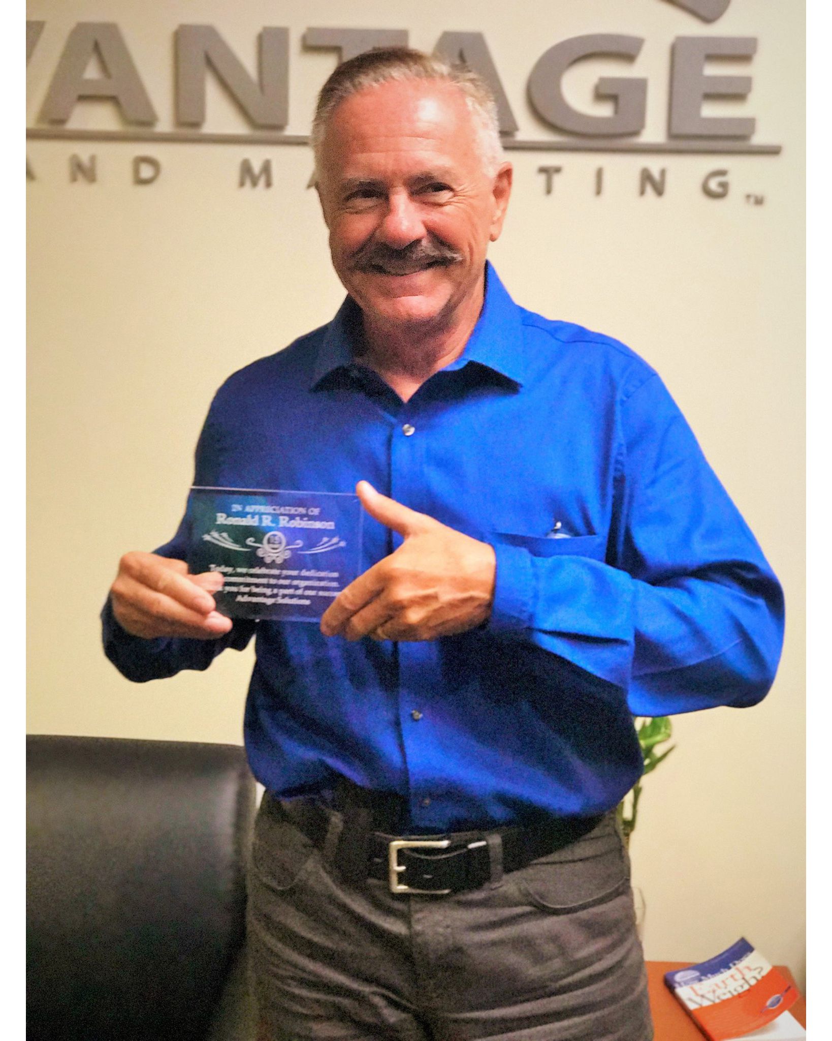 Advantage Solutions employee holding an award