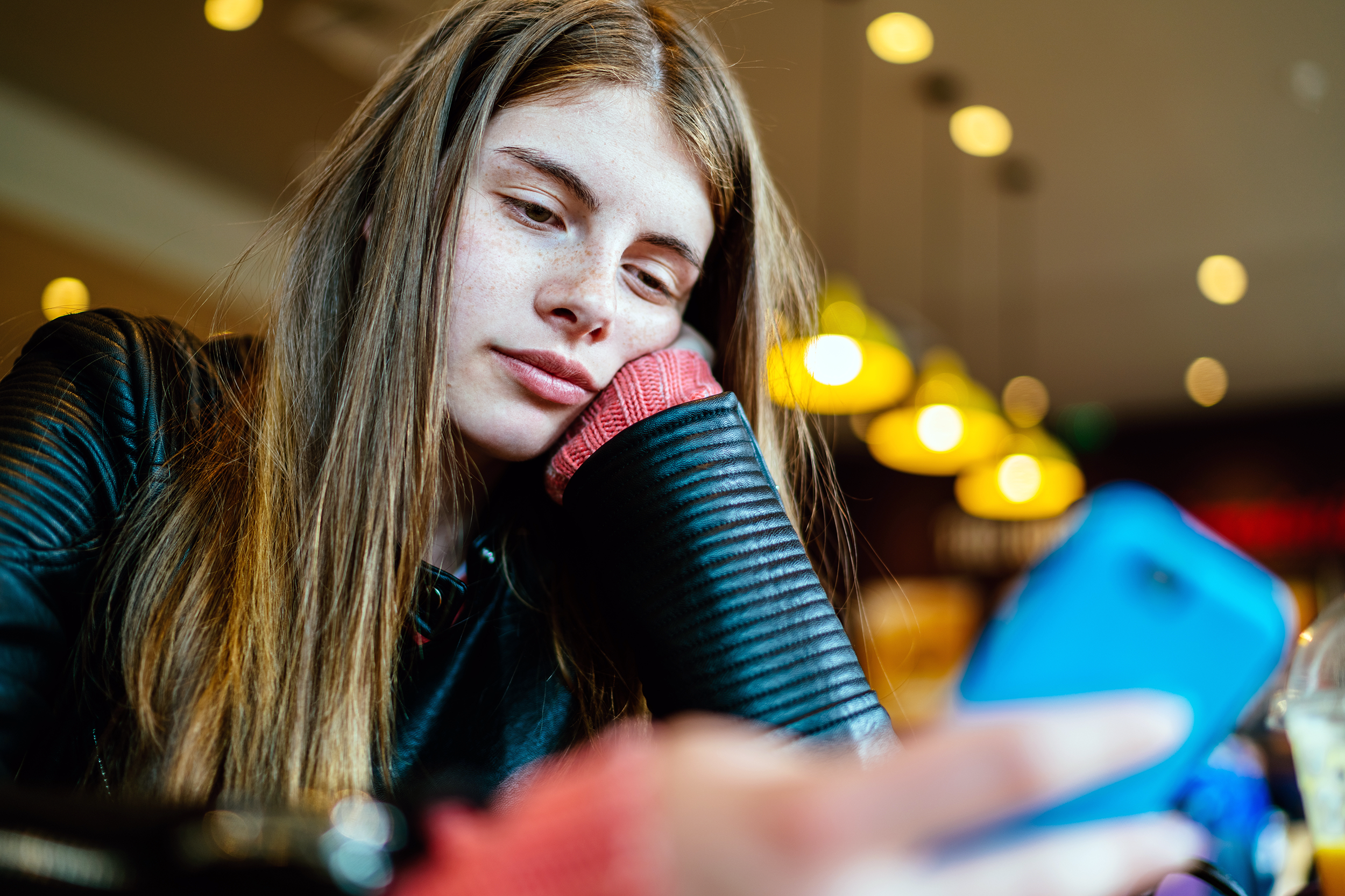 Bored teen on her phone