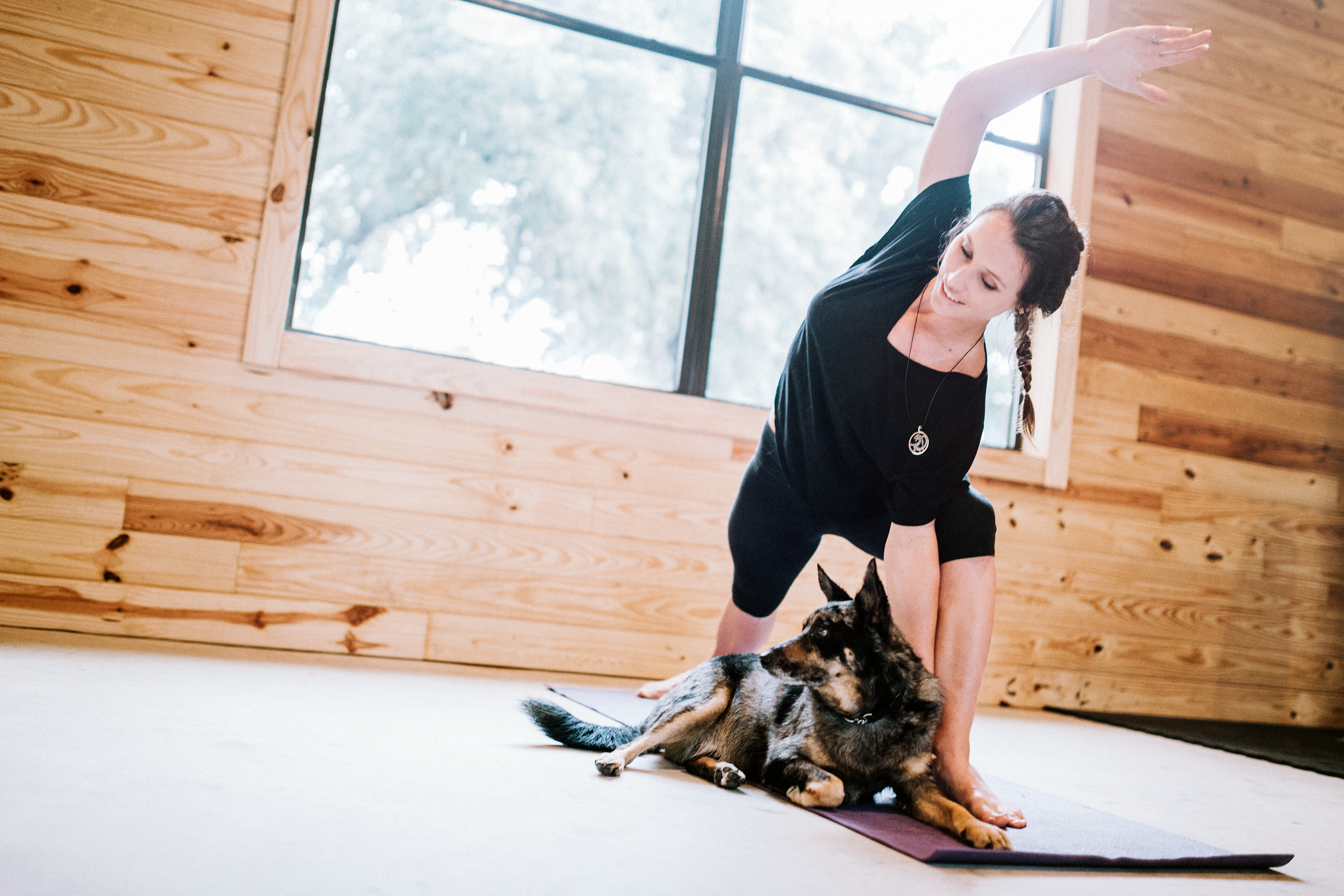 Woman doing yoga with her dog