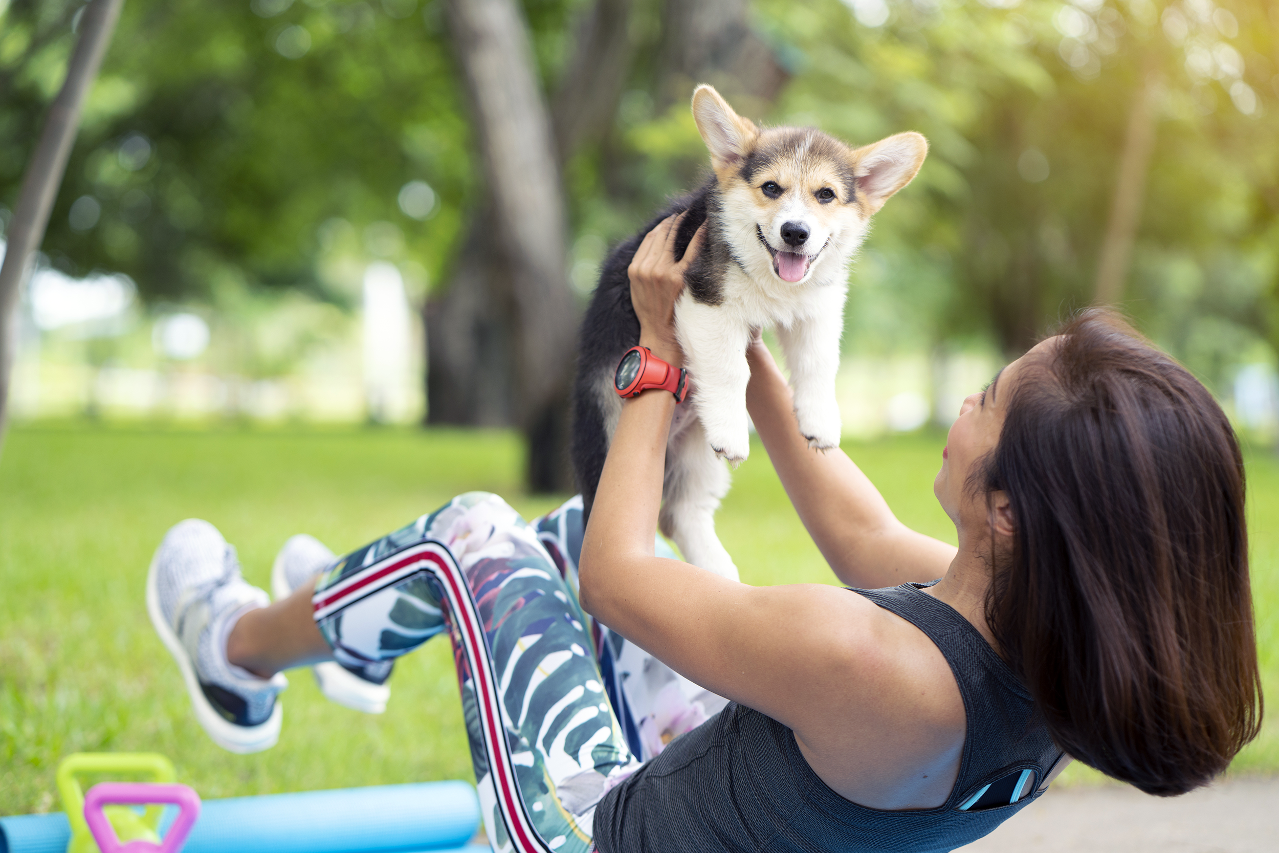 Woman exercising outside with her dog