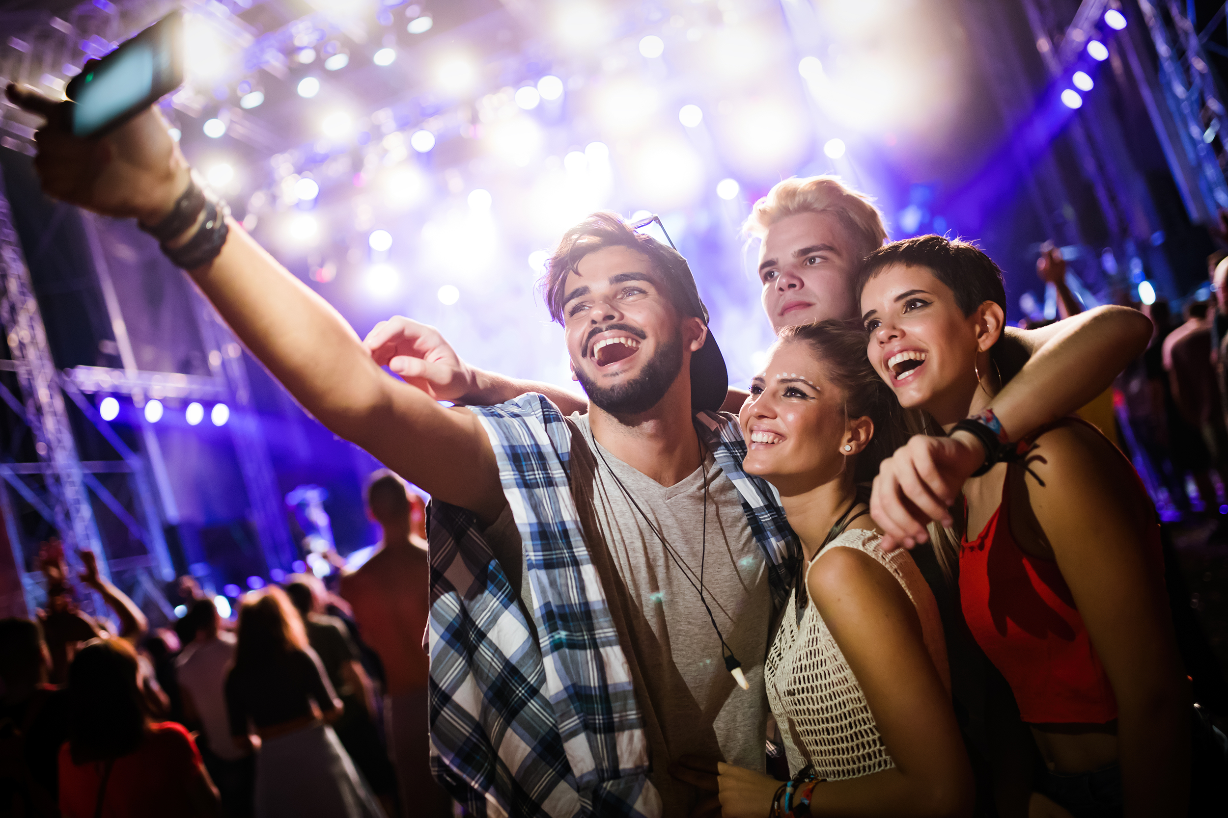 Teens taking a selfie at a concert