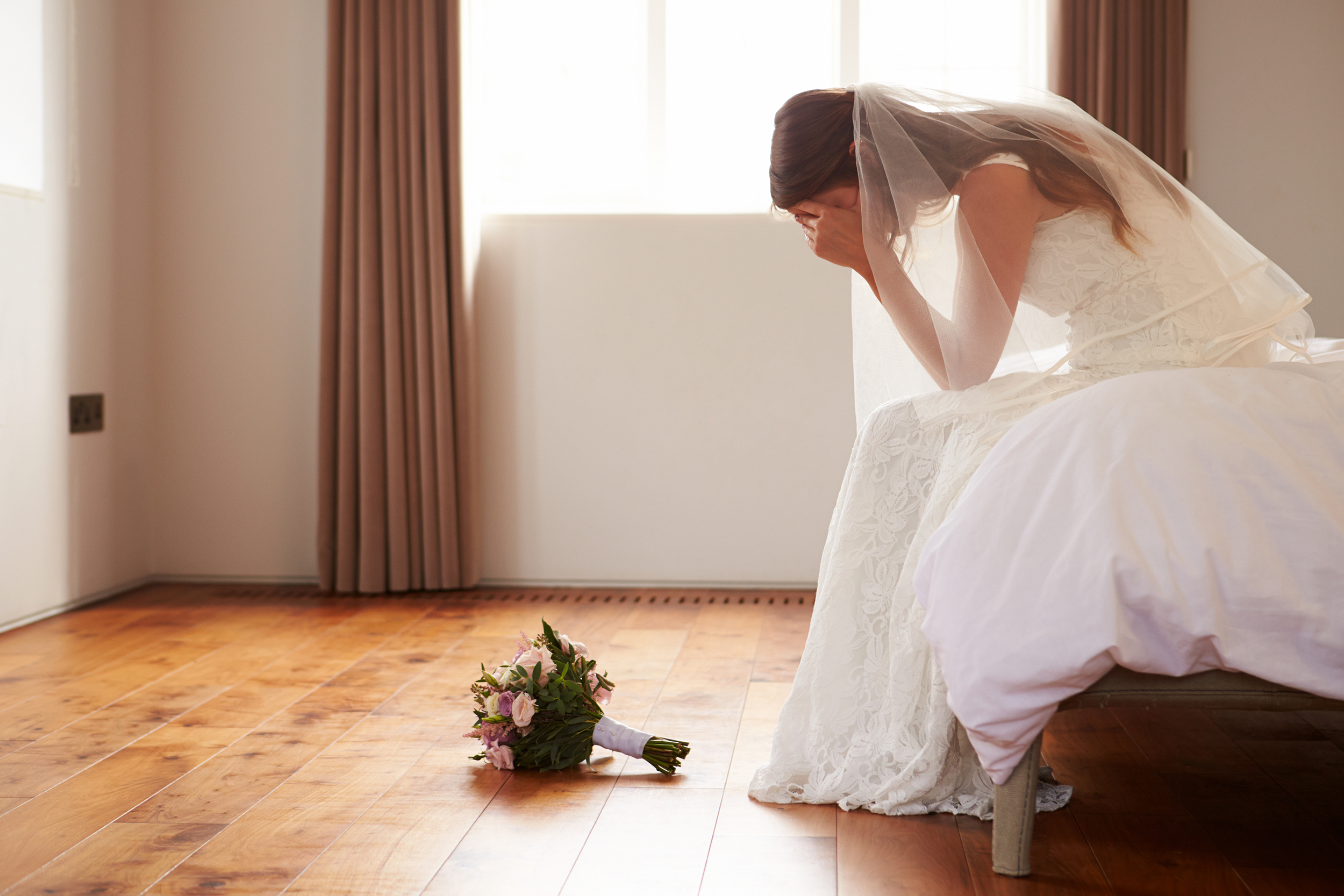 Stressed bride sitting in a hotel room