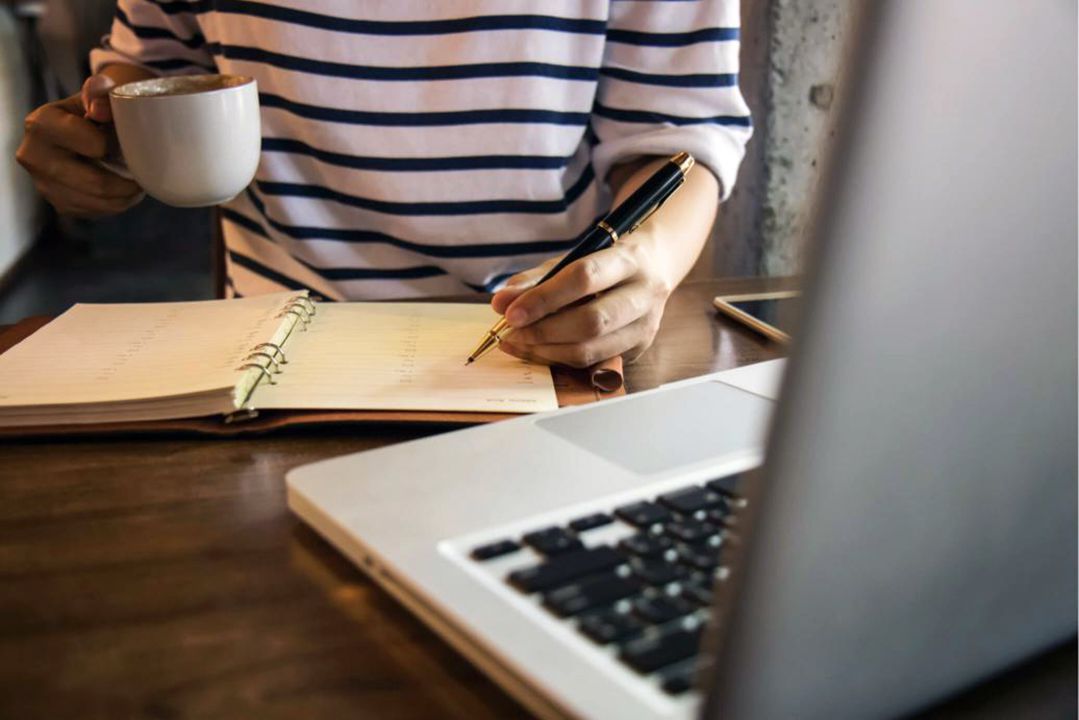 Woman working with a cup of coffee