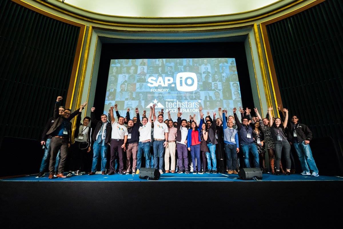 SAP employees on stage at a conference