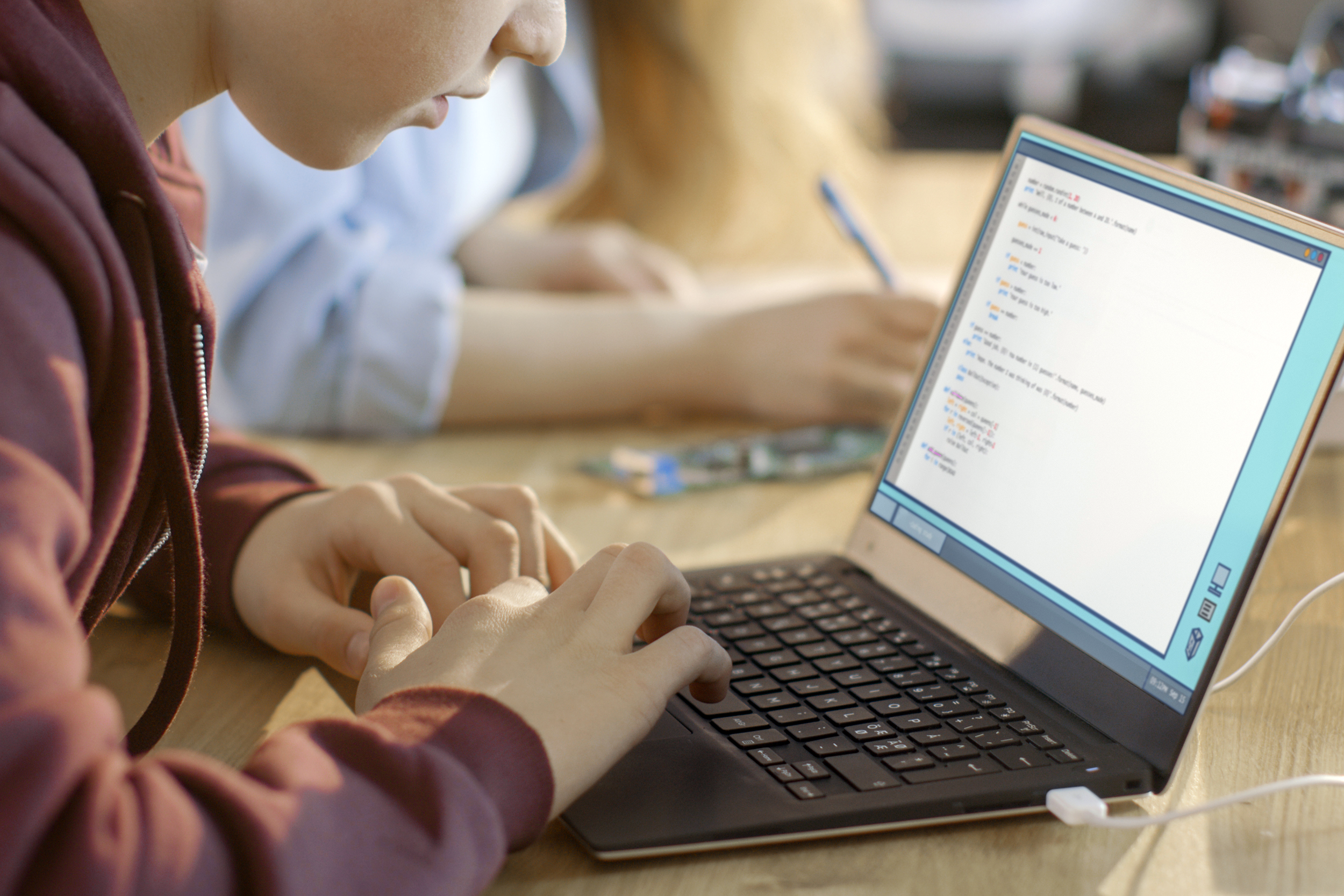 Boy in school using a laptop
