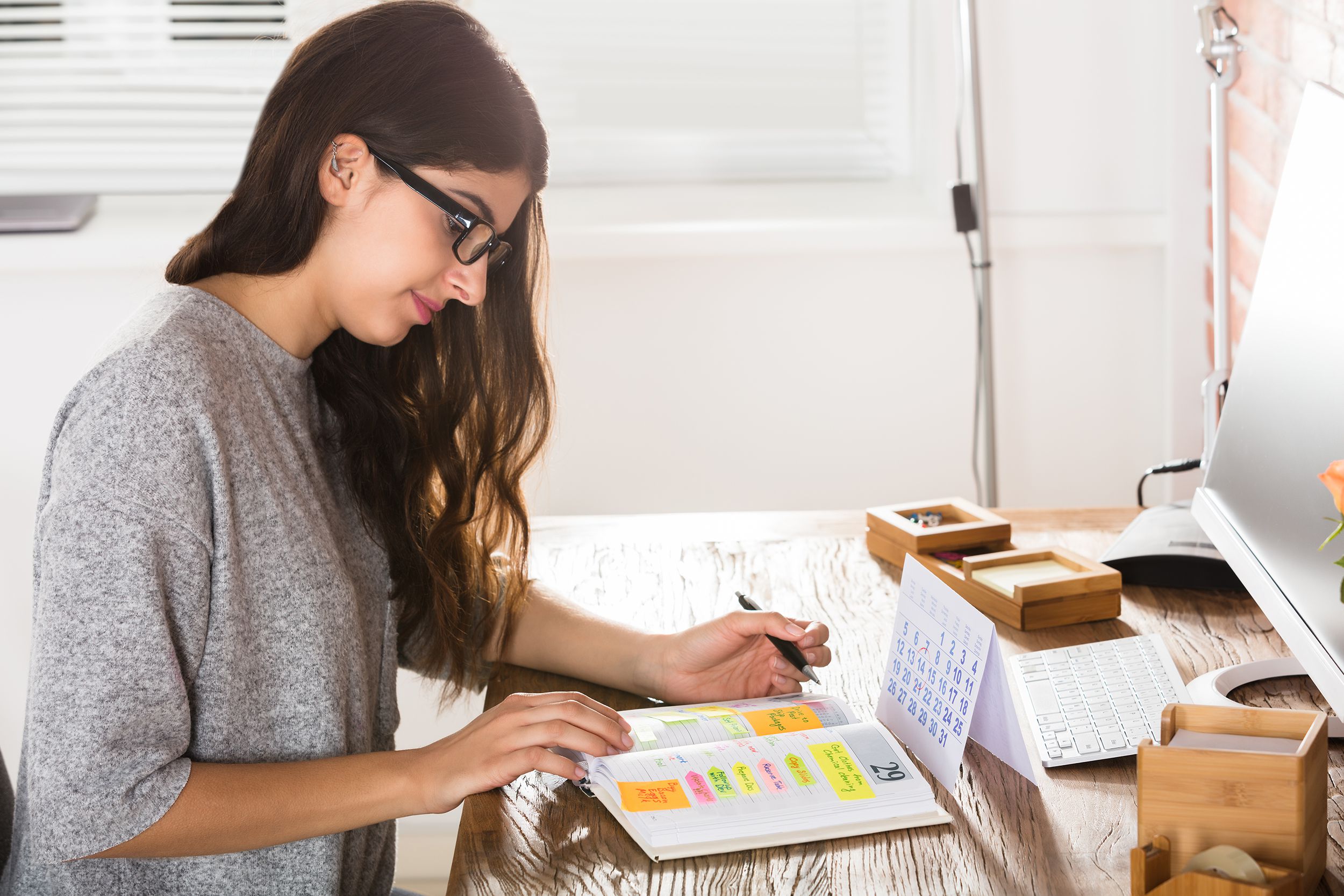 businesswoman writing schedule in diary