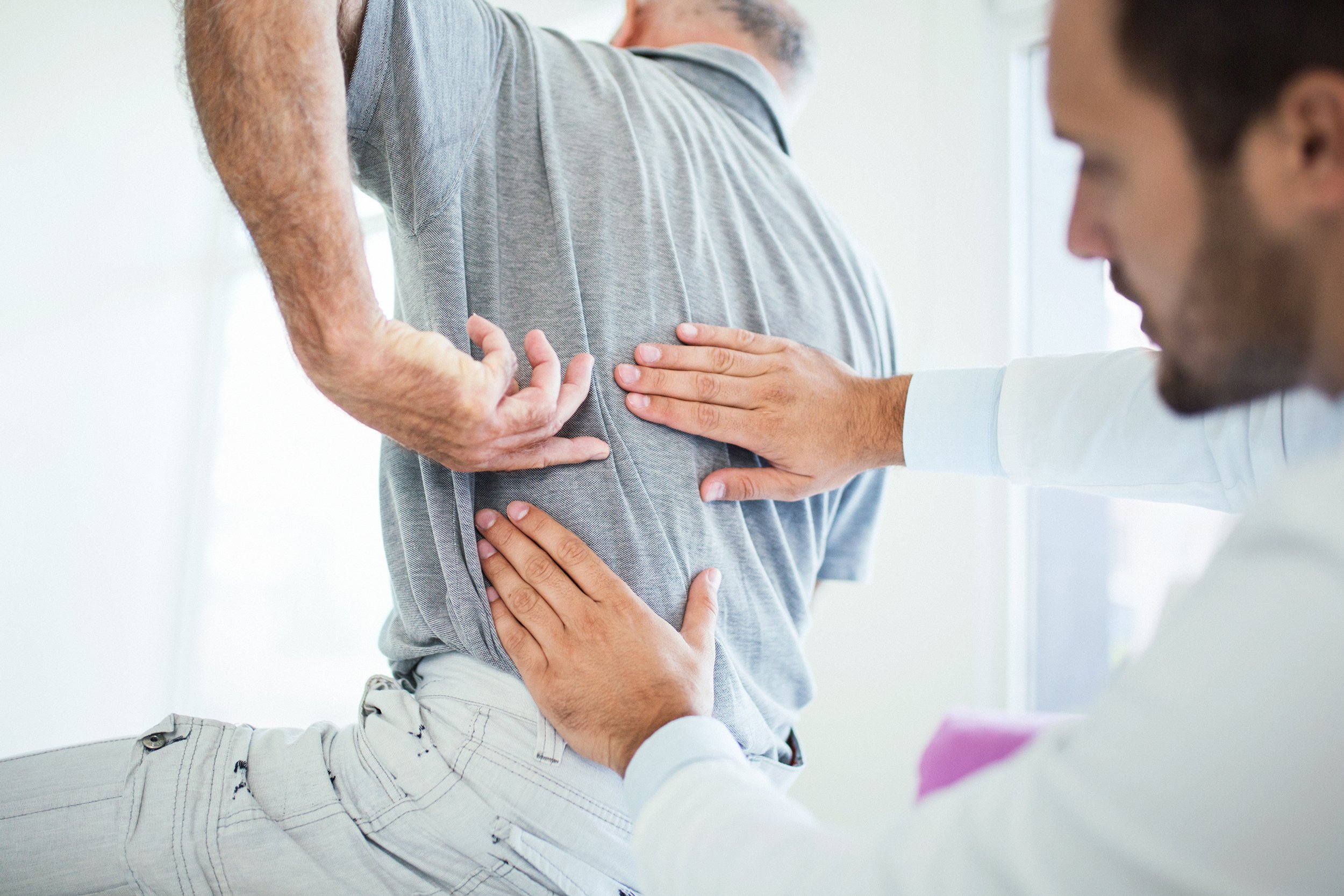 senior with back problems at doctor
